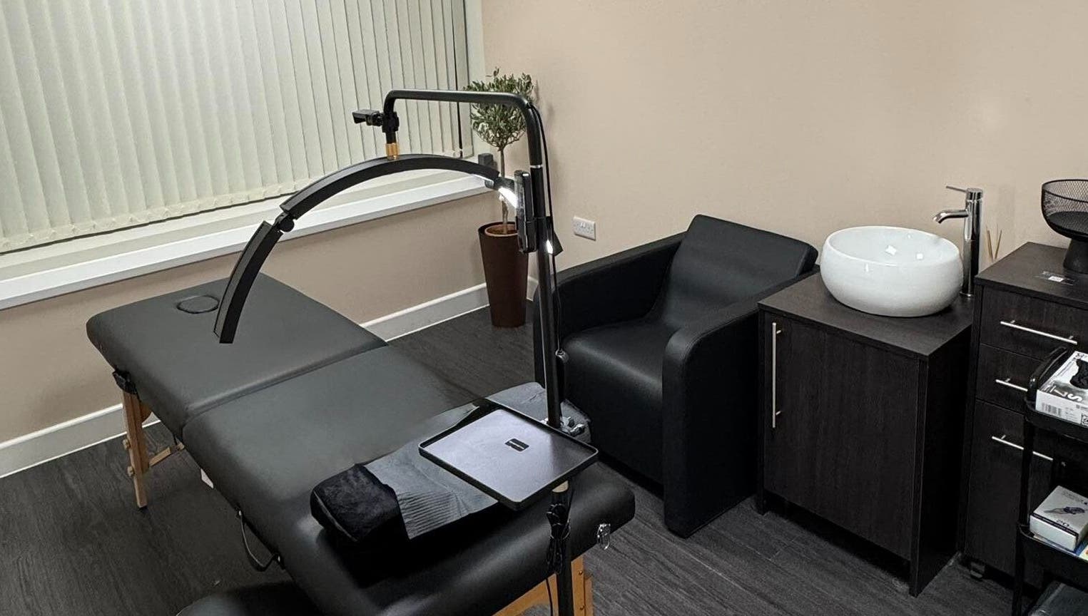 Modern treatment room at ZeZe Beauty Art in Birmingham, England, GB featuring a massage table and sleek decor.