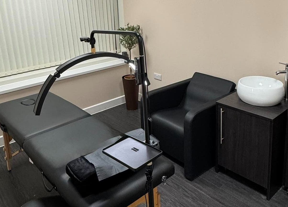 Modern treatment room at ZeZe Beauty Art in Birmingham, England, GB featuring a massage table and sleek decor.