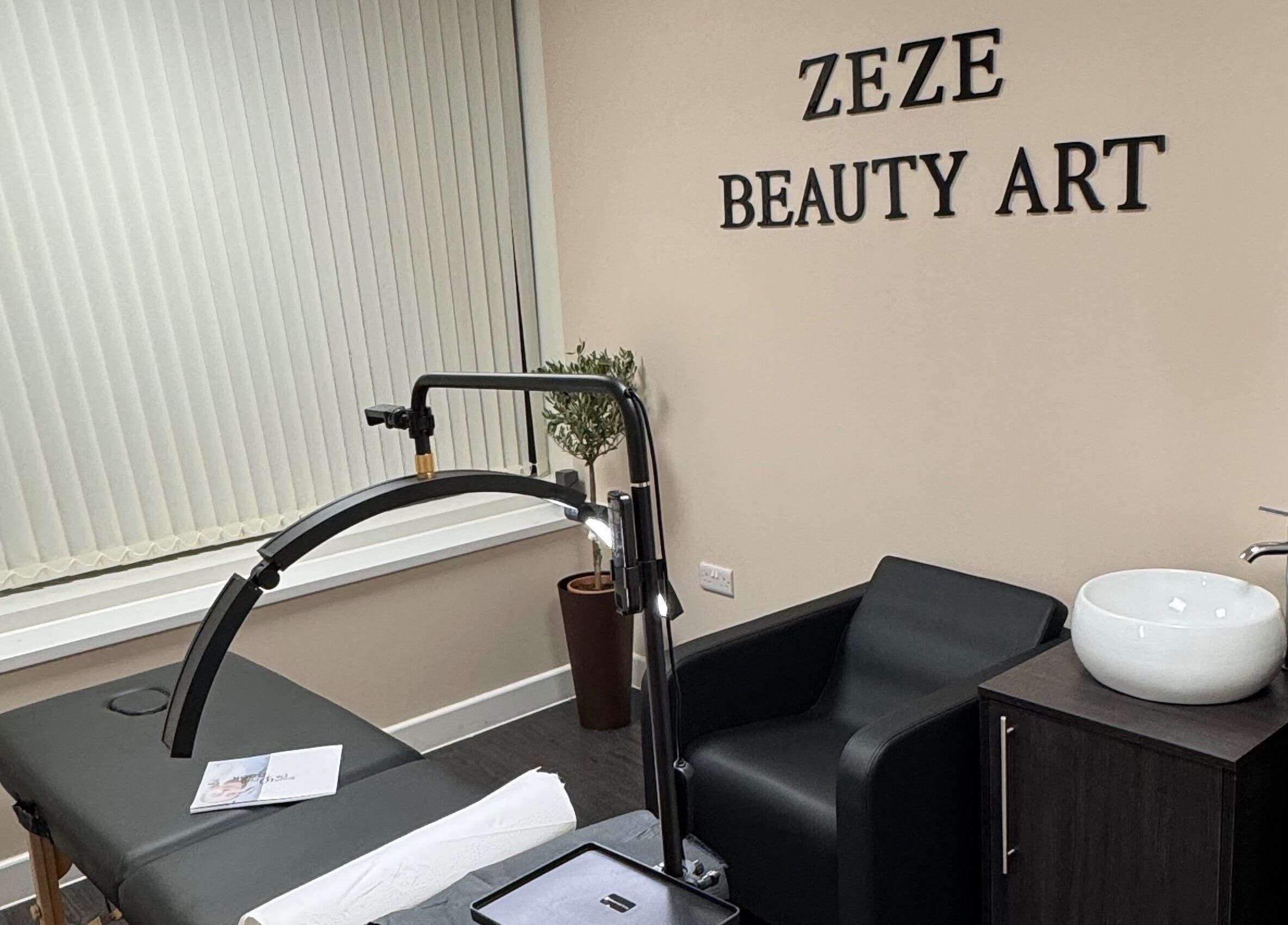 Modern treatment room at ZeZe Beauty Art in Birmingham, England, GB with sleek black chair and basin.