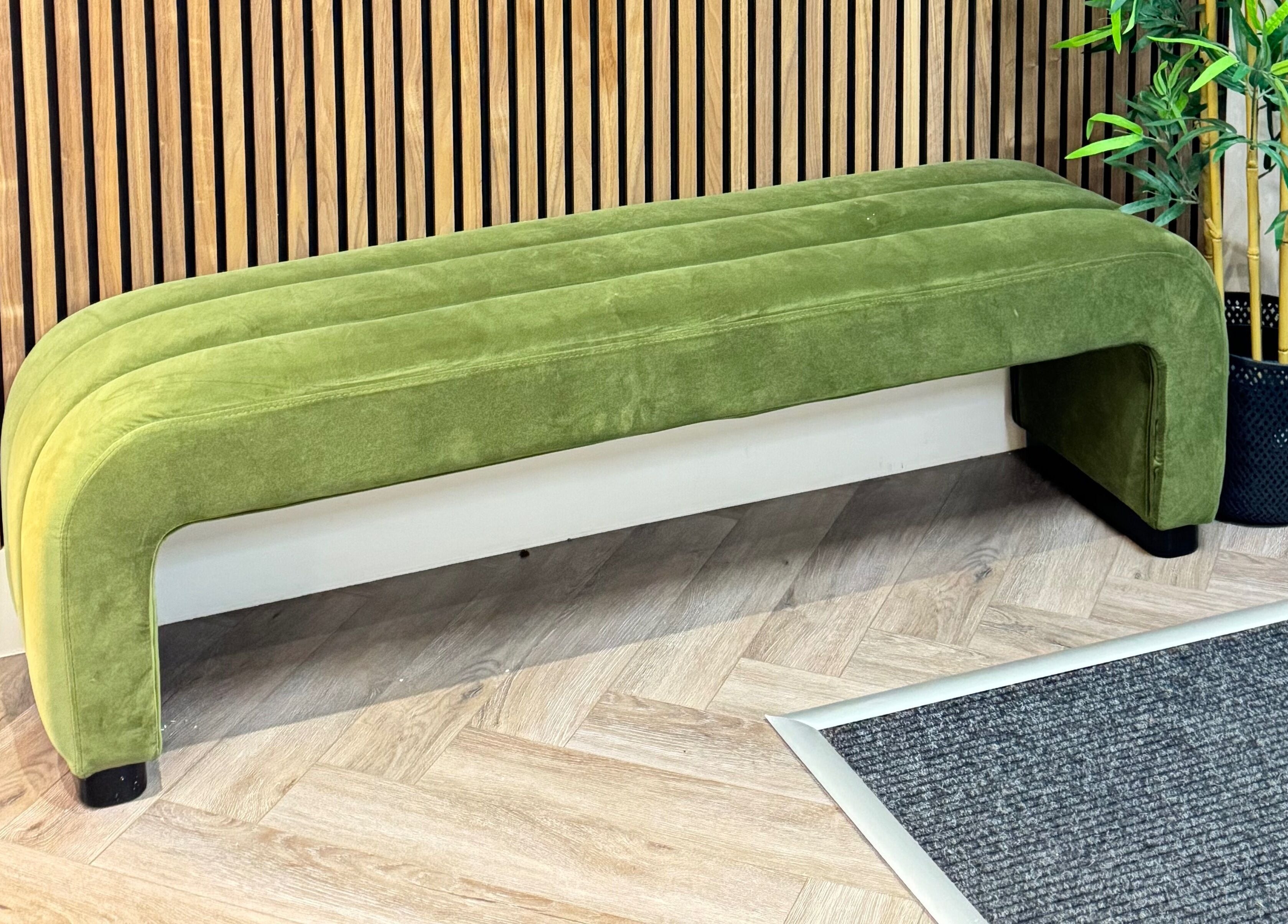 Elegant green bench at Elya Aesthetic, London, England, GB, enhancing the wellness ambience.