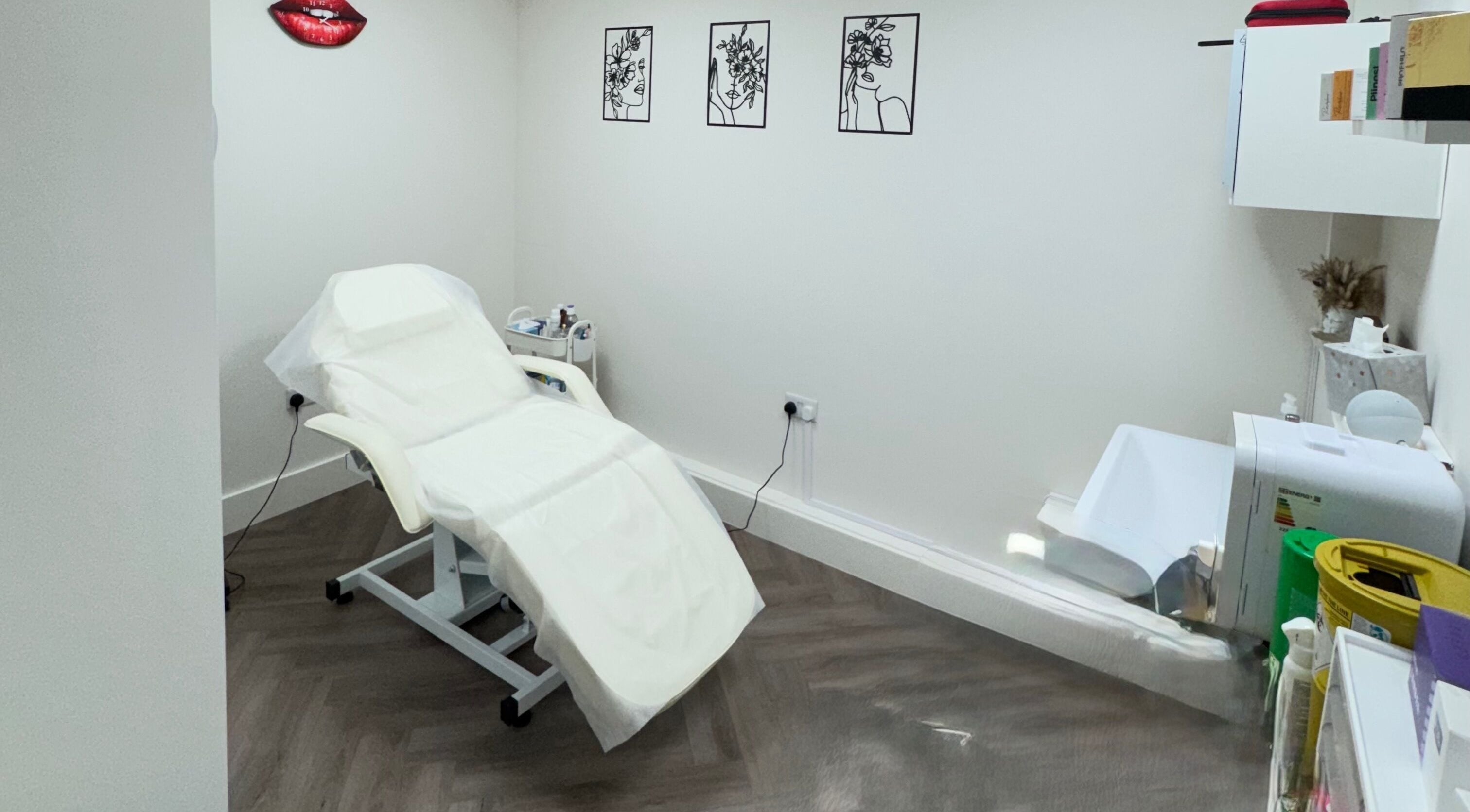 Treatment room at Elya Aesthetic, London, England, GB, featuring a reclining chair and stylish decor.