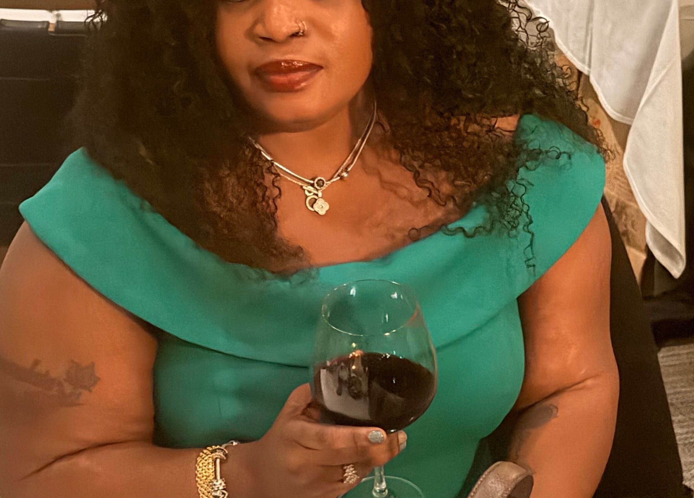 Guest enjoying a glass of wine at Tresor Hair Elegance, Dumfries, Virginia, US.