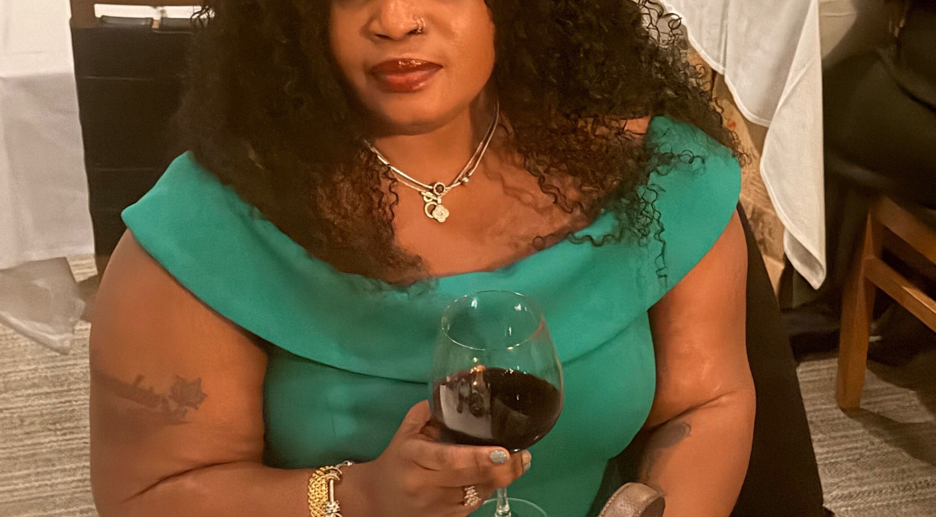 Guest enjoying a glass of wine at Tresor Hair Elegance, Dumfries, Virginia, US.