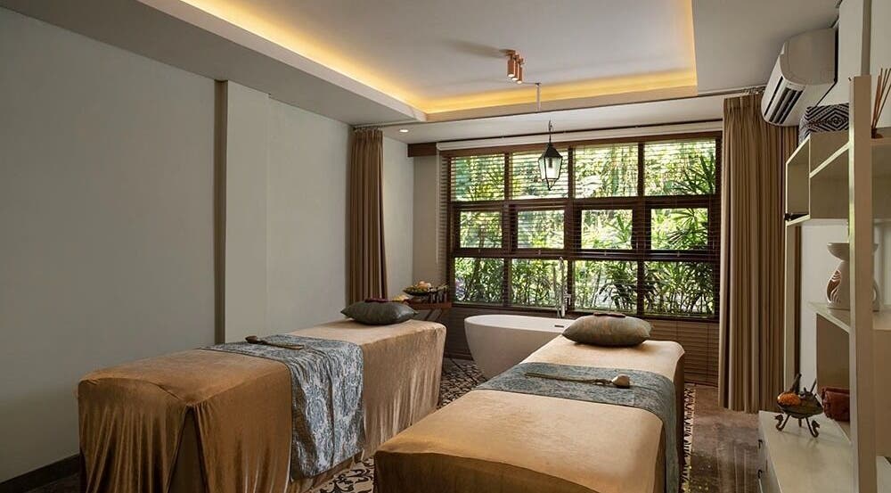 Relaxing treatment room at Tejas Spa Bisma, Bali, Bali, ID with two massage tables and a serene ambiance.