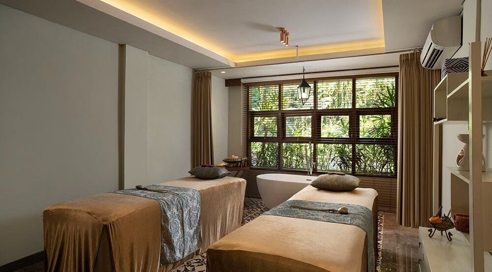 Relaxing treatment room at Tejas Spa Bisma, Bali, Bali, ID with two massage tables and a serene ambiance.
