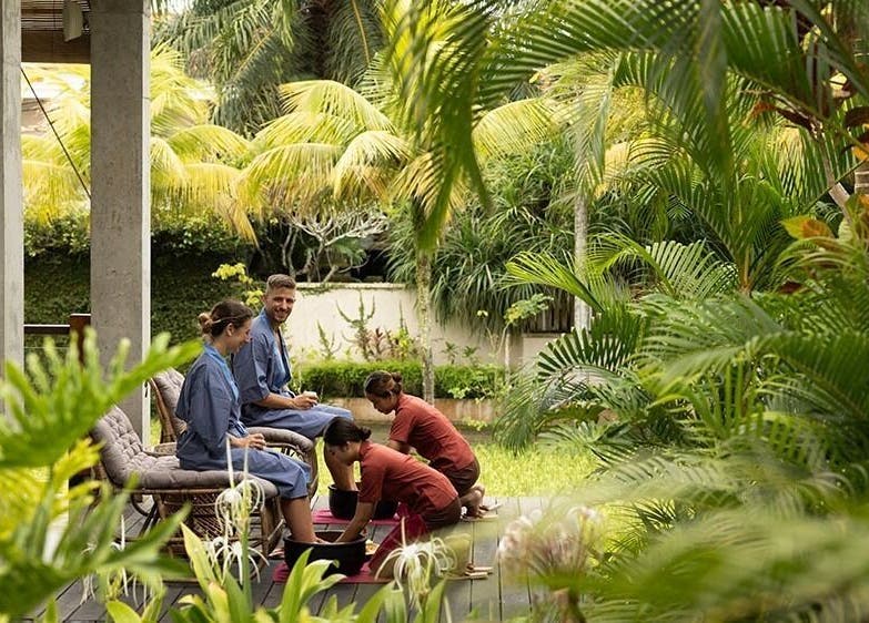 Relaxing foot spa in lush garden at Tejas Spa Bisma, Bali, Bali, ID, offering a tranquil outdoor experience.