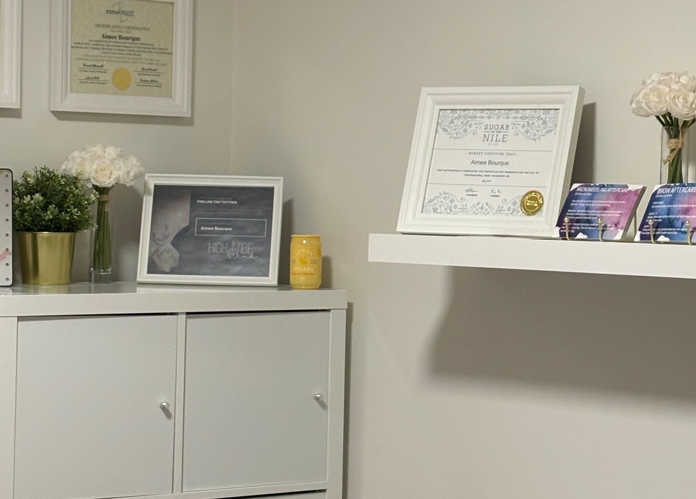 Chic interior of Chi Beauty by Aimee showcasing certificates and decor in Calgary, Alberta, CA.