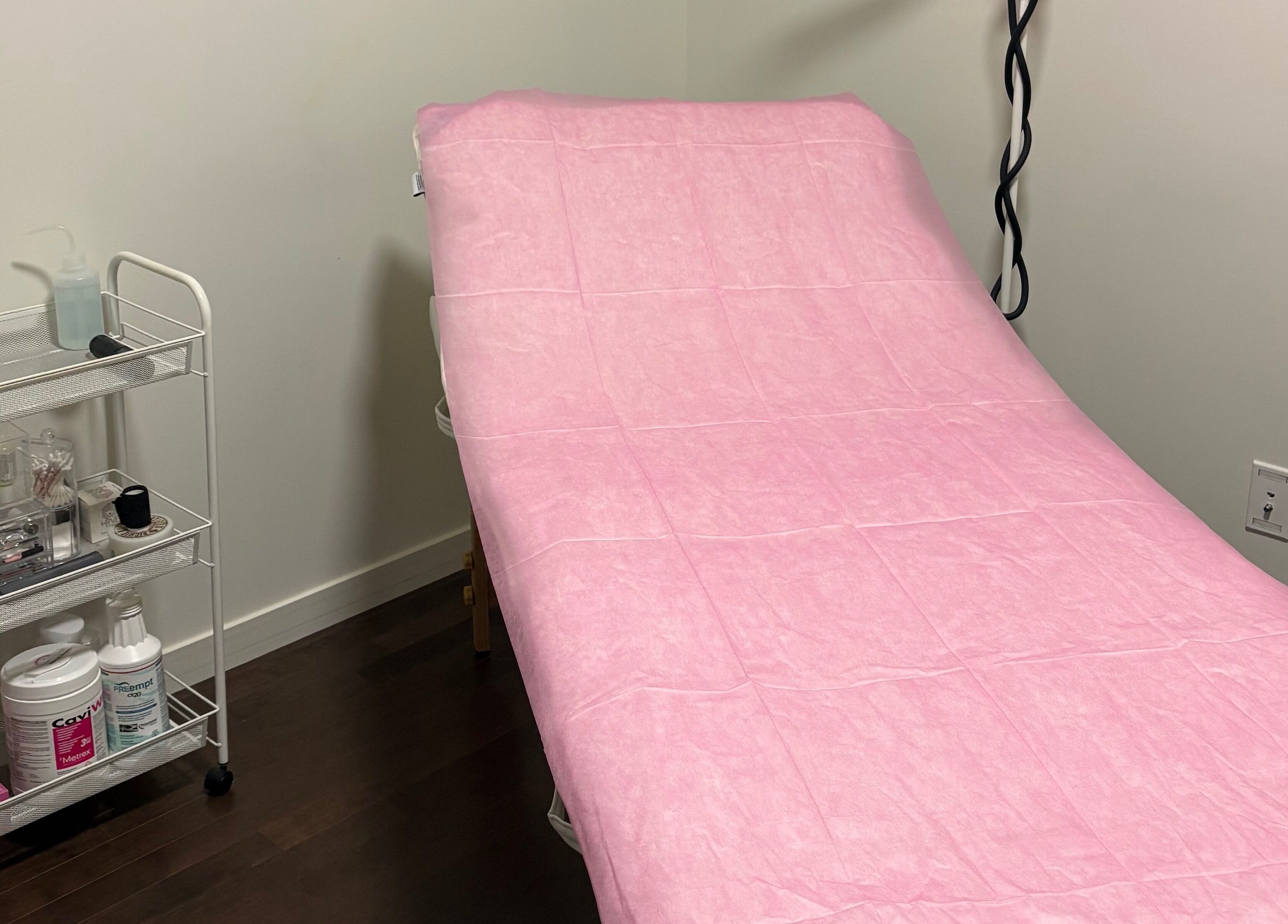 Treatment bed at Chi Beauty by Aimee, Calgary, Alberta, CA, covered in pink for relaxation.