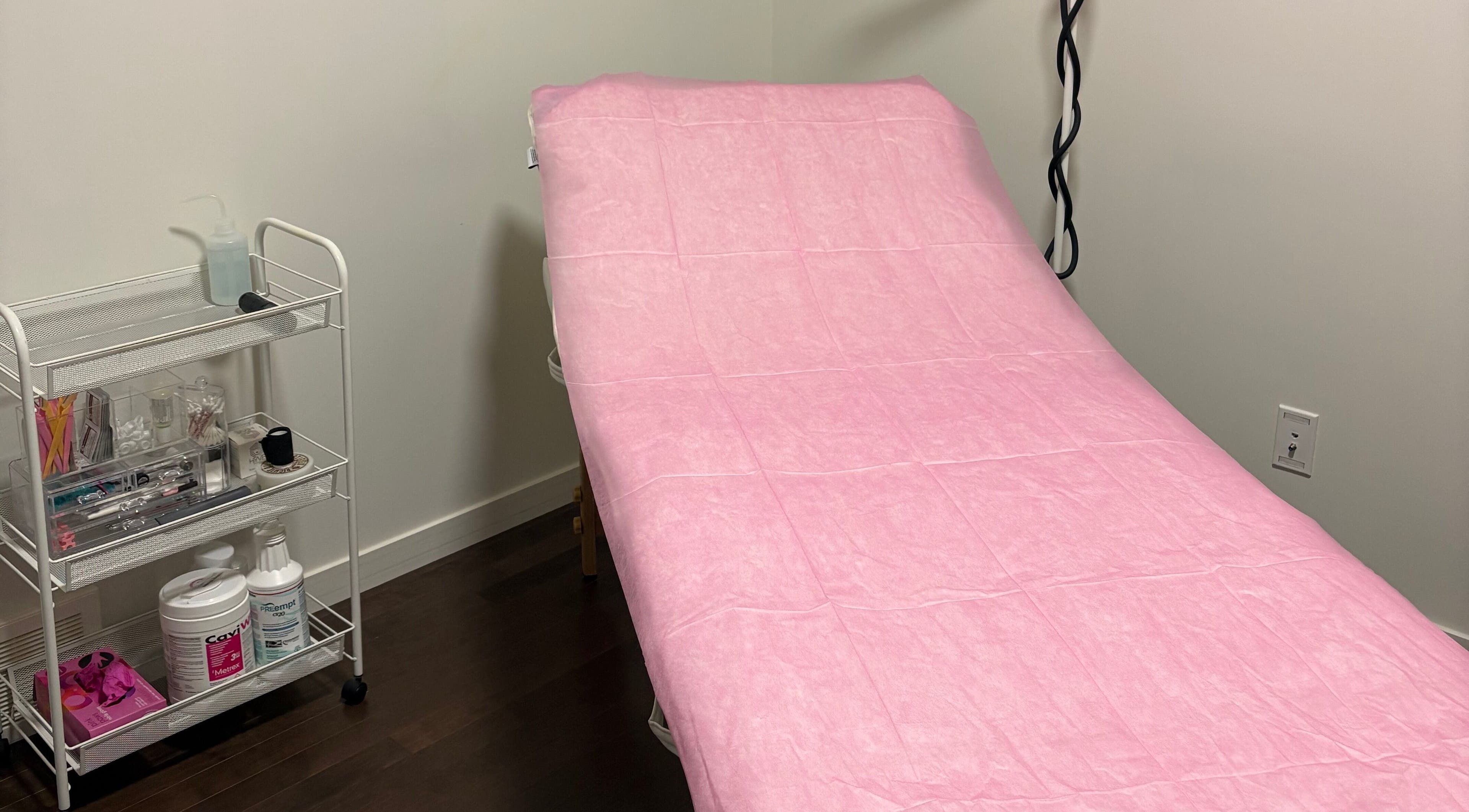 Treatment bed at Chi Beauty by Aimee, Calgary, Alberta, CA, covered in pink for relaxation.