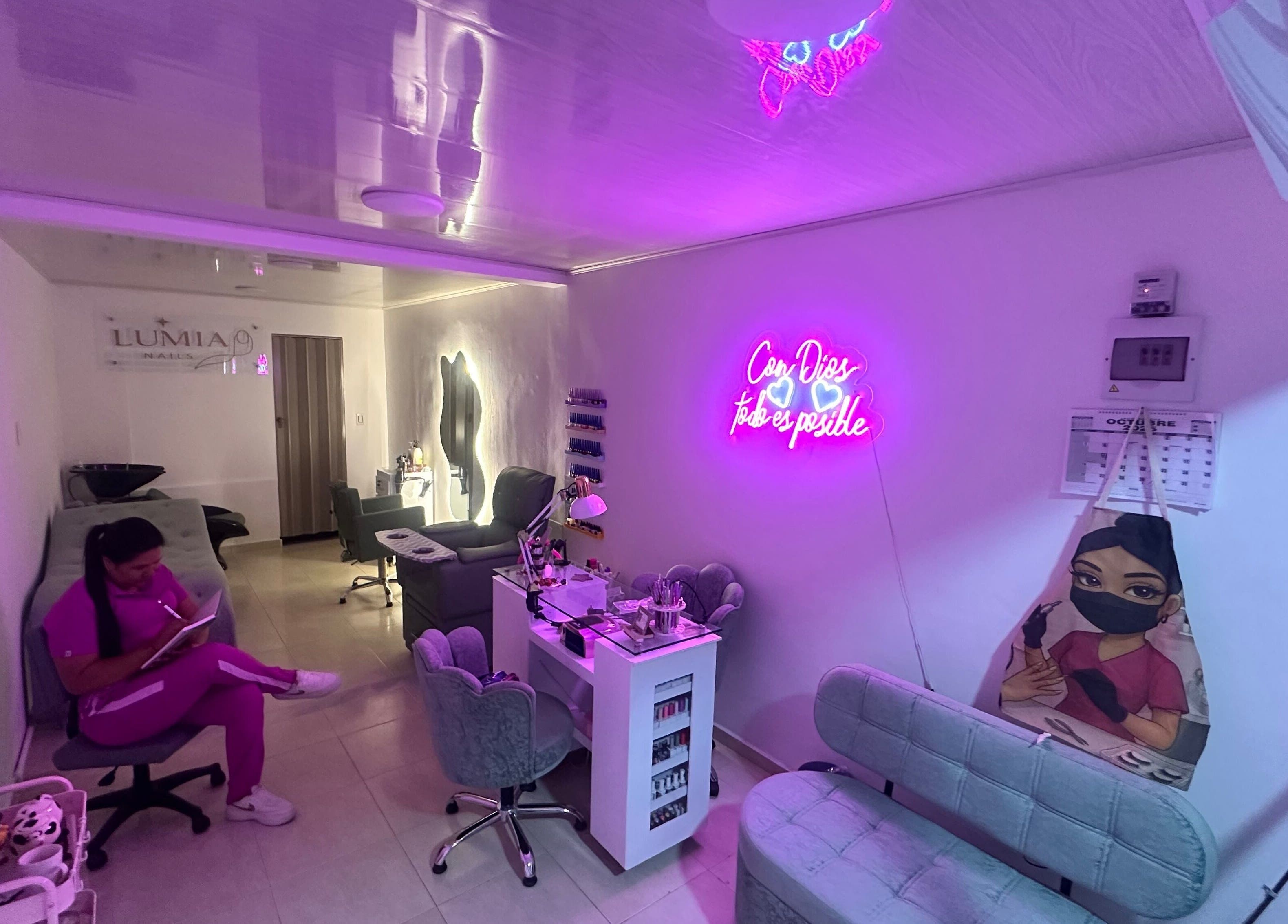 Stylish interior of Lúmia_.nails in Cali, Valle Del Cauca, CO with neon lights and cozy seating areas.