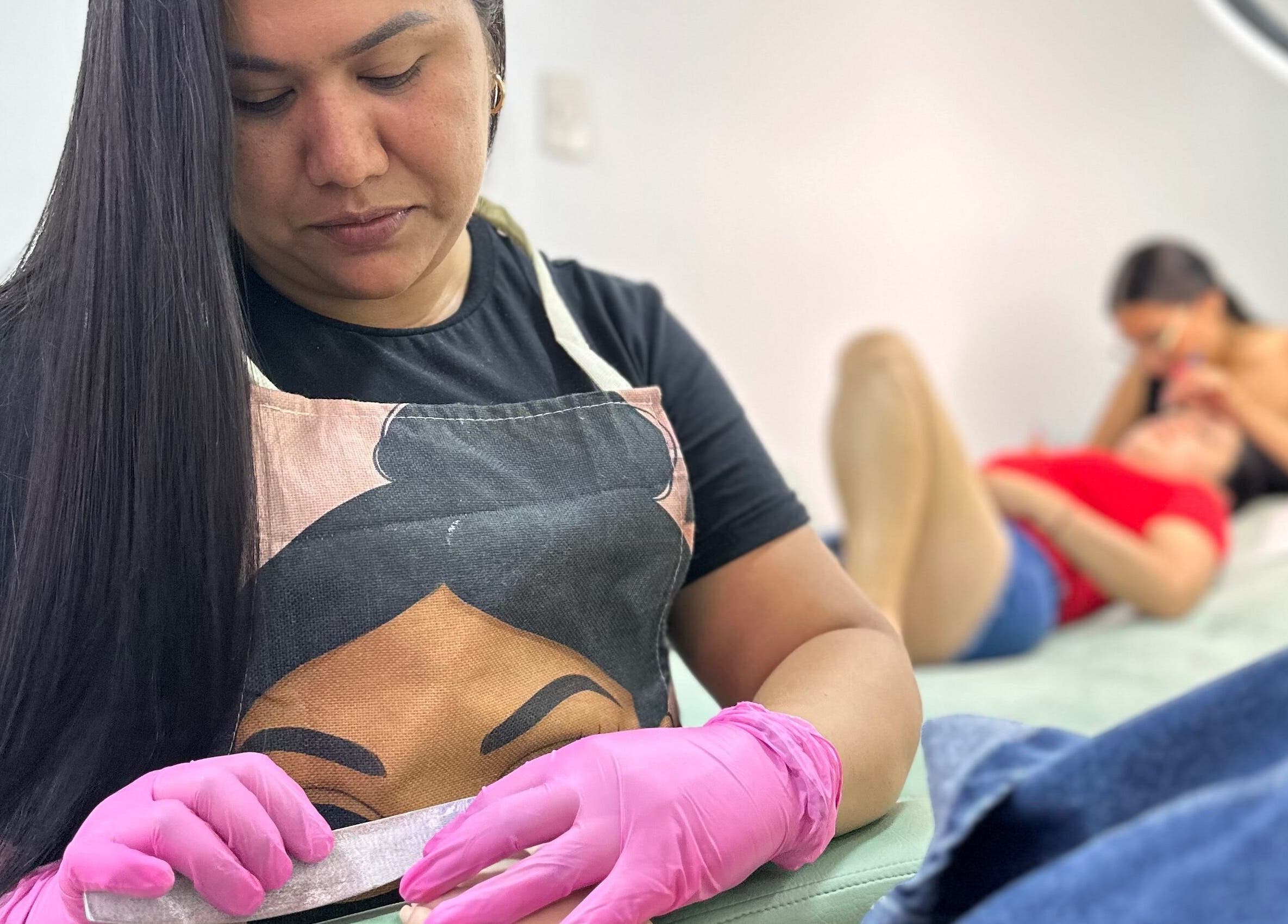 Manicure session at Lúmia_.nails in Cali, Valle Del Cauca, CO. Nail artist in pink gloves perfects nail treatment.