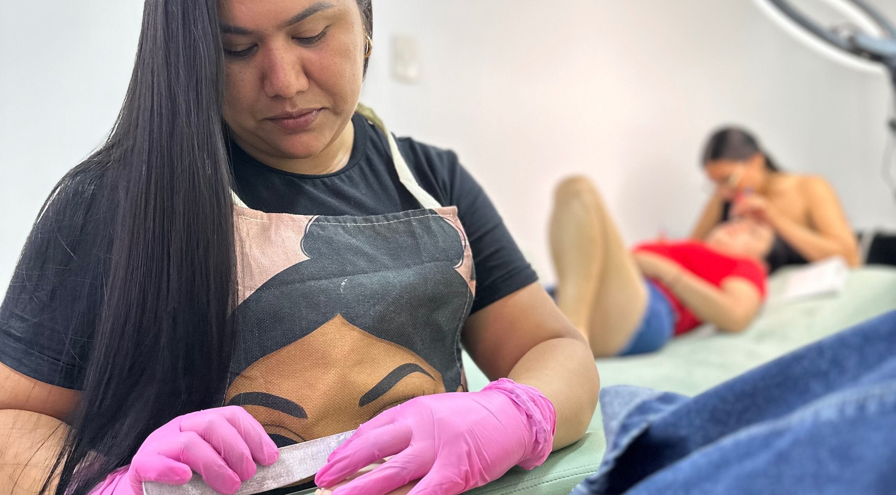 Manicure session at Lúmia_.nails in Cali, Valle Del Cauca, CO. Nail artist in pink gloves perfects nail treatment.