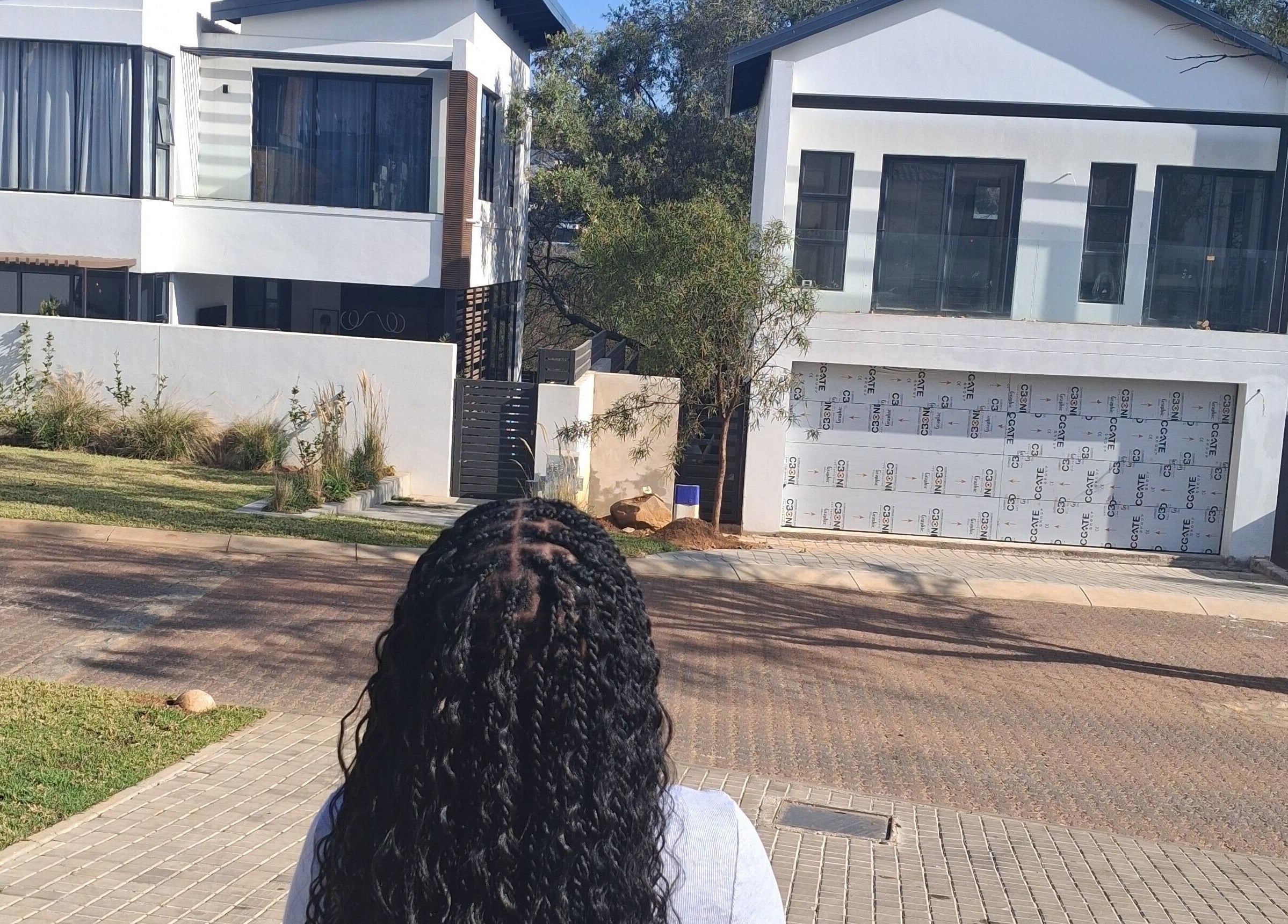 Back view of a woman with braided hair at Hairdressers of the North, Roodepoort, Gauteng, ZA.