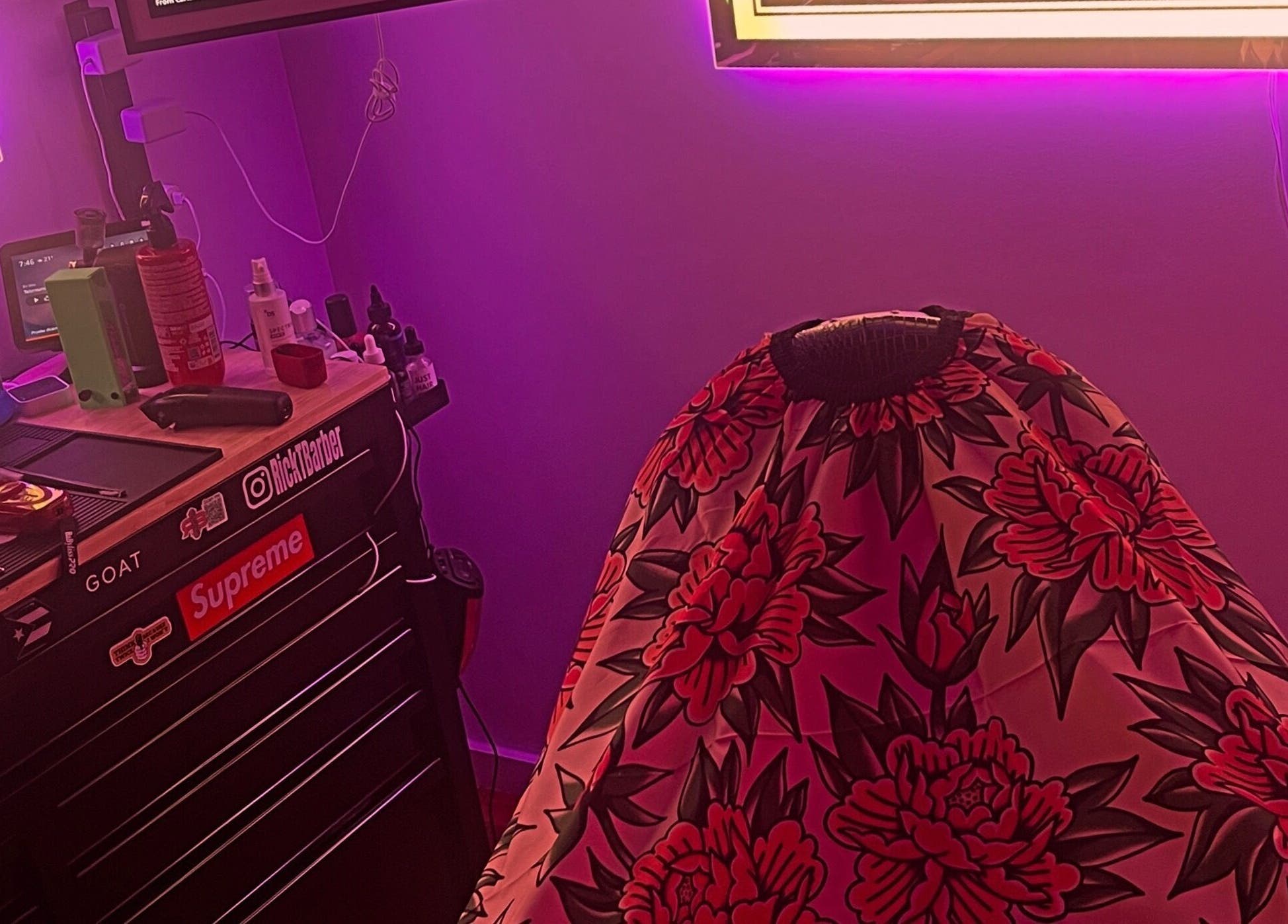 Ricktbarber's vibrant barber station in Springfield, Massachusetts, US with colorful cape and trendy decor.