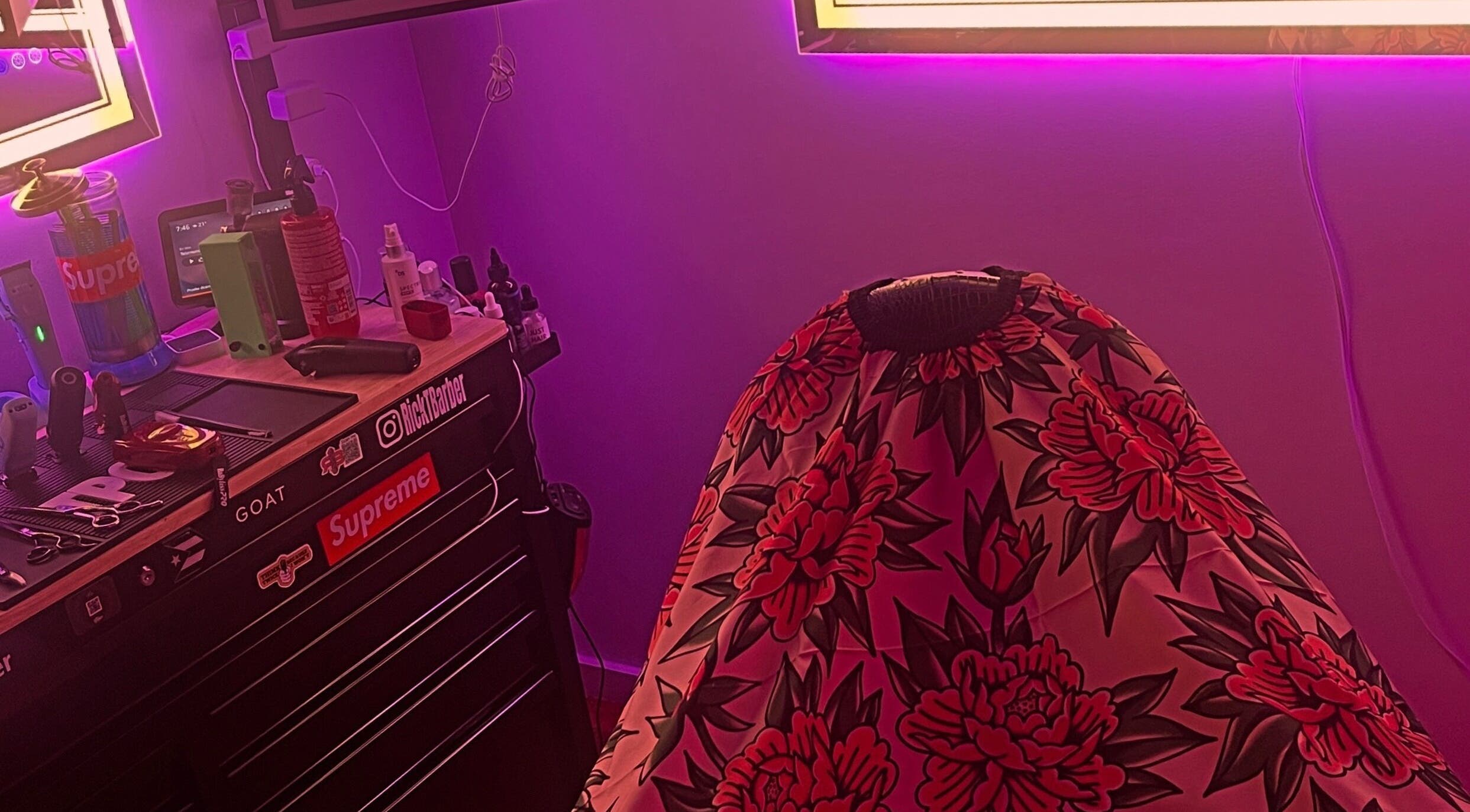 Ricktbarber's vibrant barber station in Springfield, Massachusetts, US with colorful cape and trendy decor.