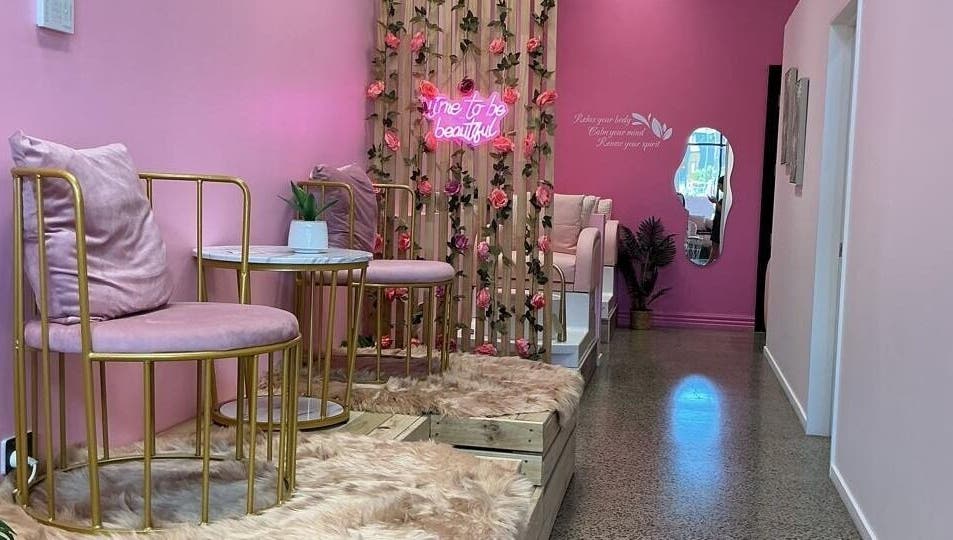 Plush pink seating and floral decor at City Nails & Beauty Studio, Christchurch, Canterbury Region, NZ.