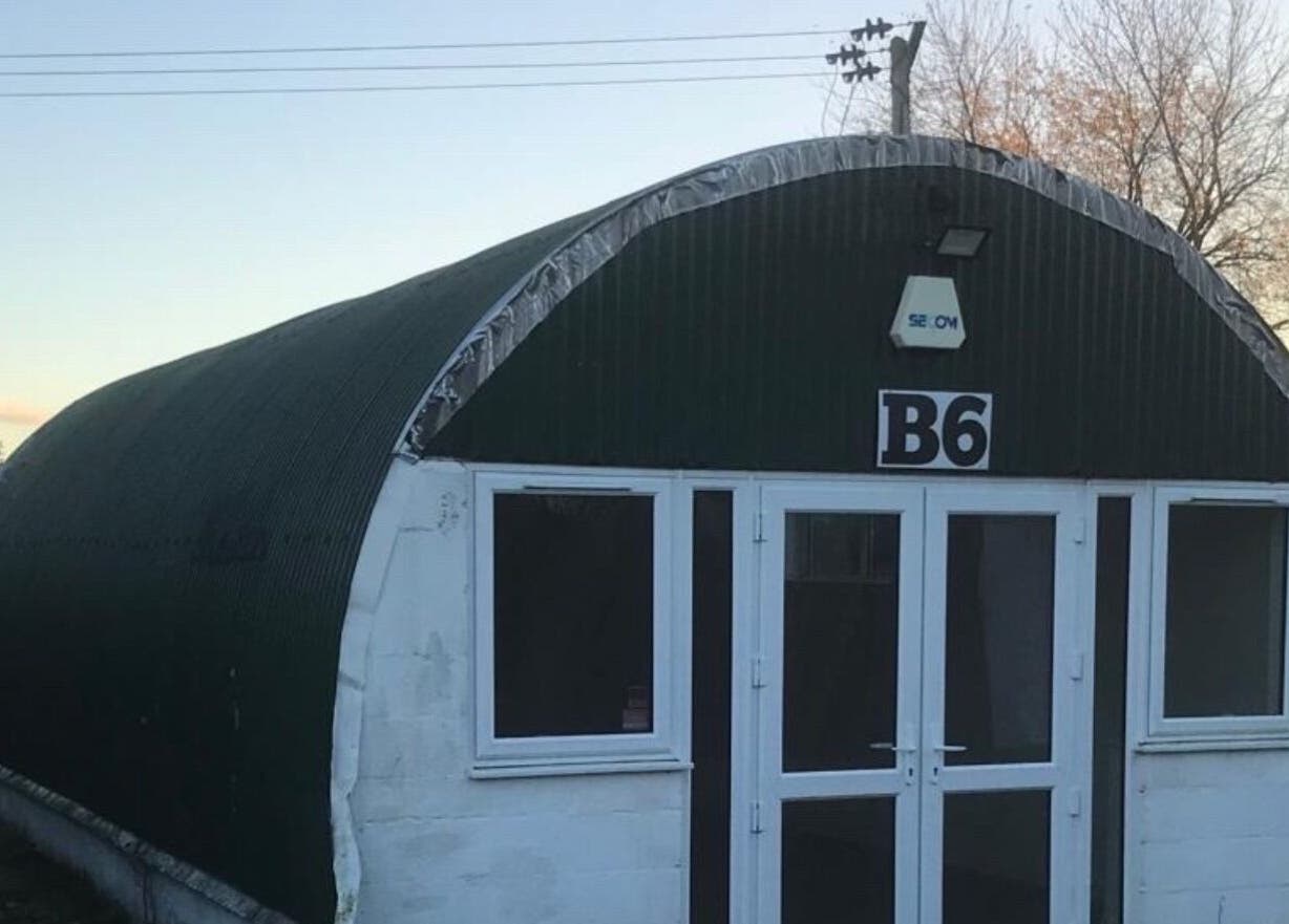 Exterior view of Fabulook Fitness UK, Royston, England, GB, featuring a unique green arch building.