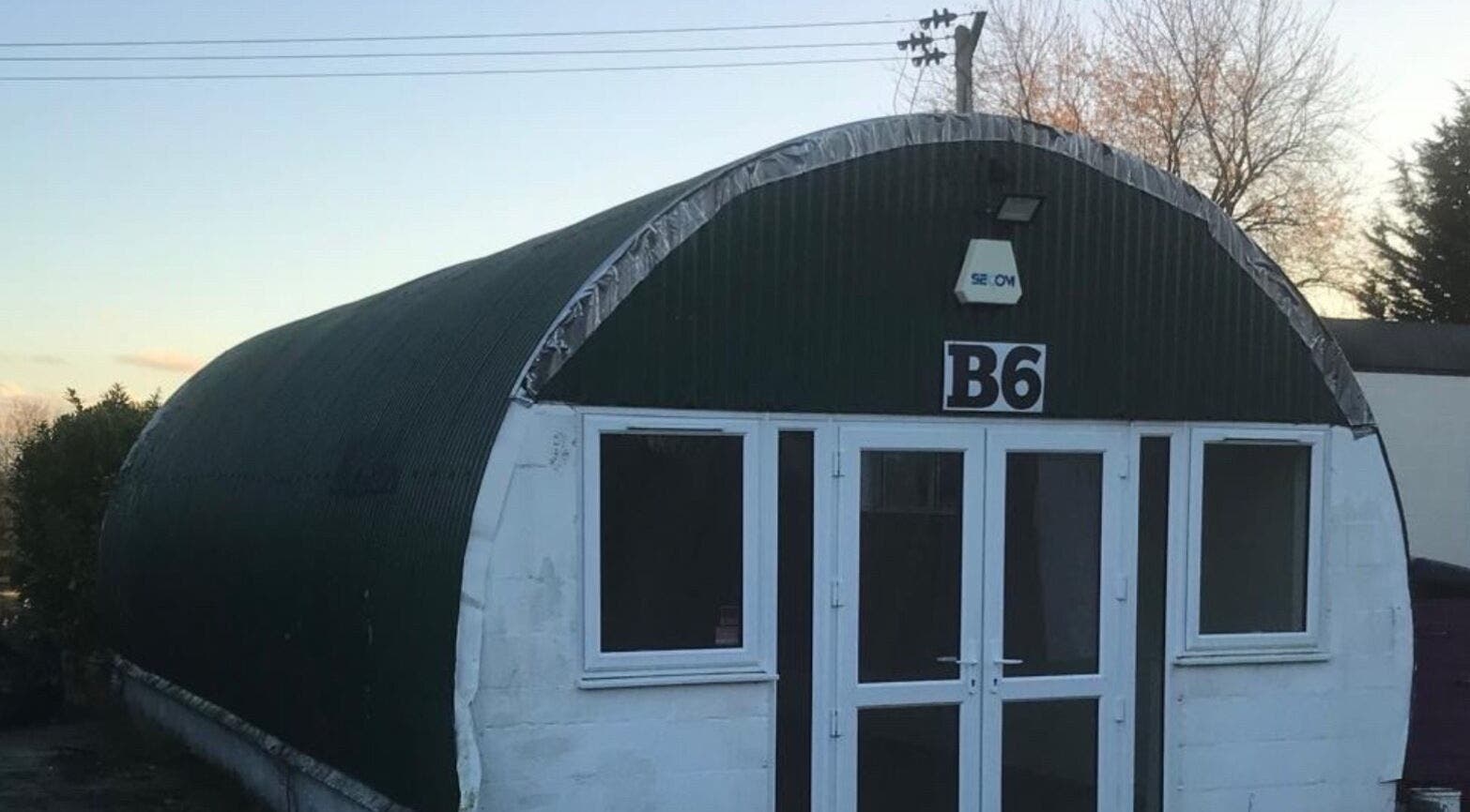 Exterior view of Fabulook Fitness UK, Royston, England, GB, featuring a unique green arch building.