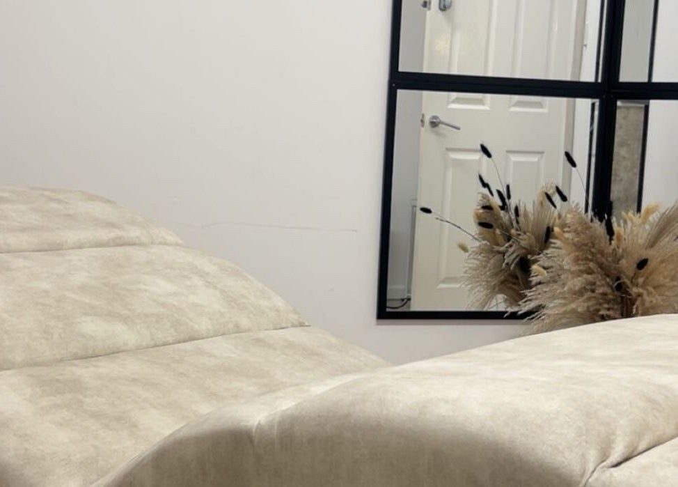 Relaxing treatment room at Contourè, Weston-super-mare, England, GB with plush seating and calming decor.