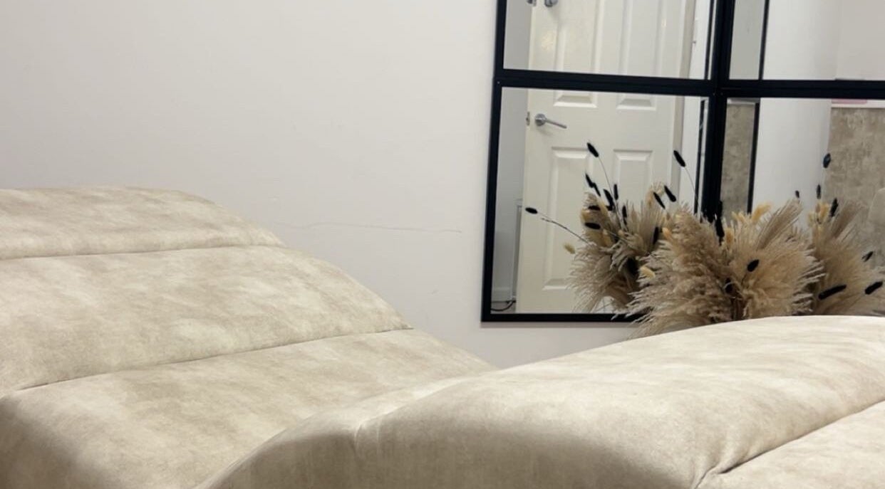 Relaxing treatment room at Contourè, Weston-super-mare, England, GB with plush seating and calming decor.