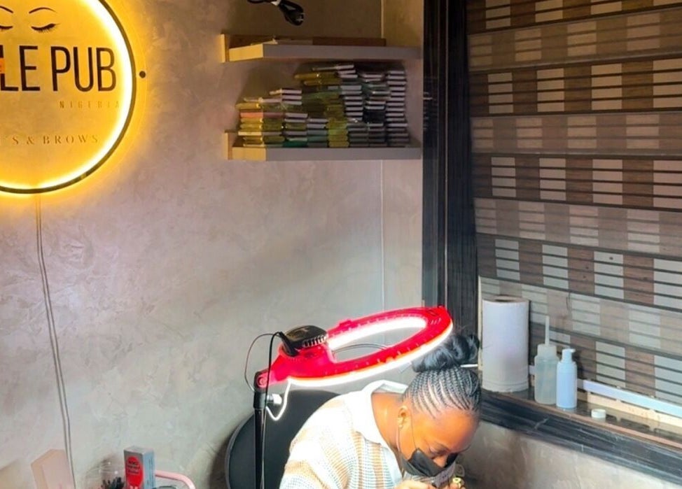 The Belle pub's cozy interior in Gwarinpa, Federal Capital Territory, NG, showcasing beauty services ambiance.