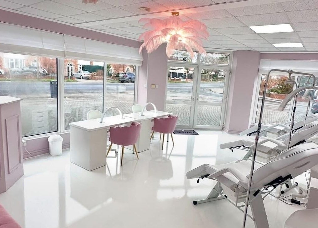 Elegant interior of casiejeanlashes in Birmingham, England, GB, featuring plush seating and modern styling stations.