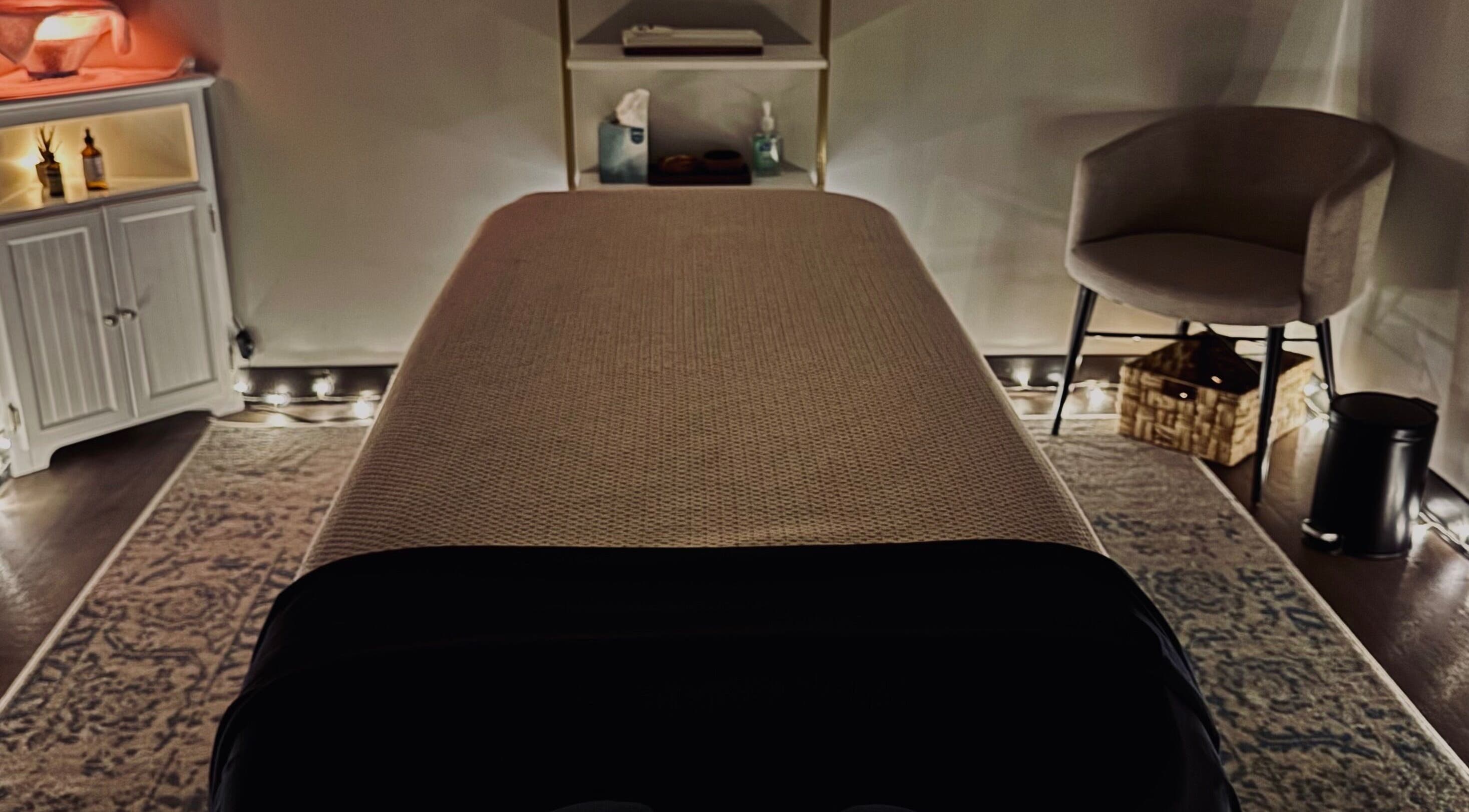 Cozy massage room at StillPoint Massage & Bodywork, Leesburg, Virginia, US with soft lighting and serene decor.