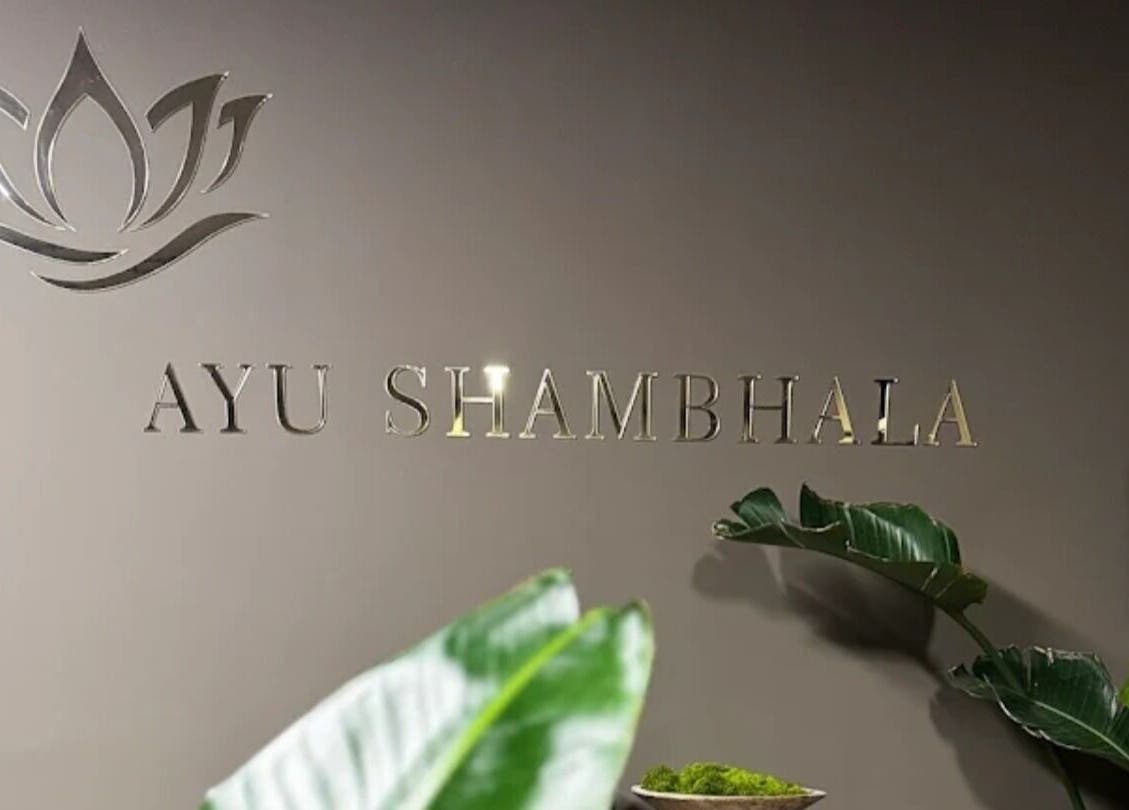 Ayu Shambhala entrance with elegant signage and plants in Łódź, Województwo Łódzkie, PL.
