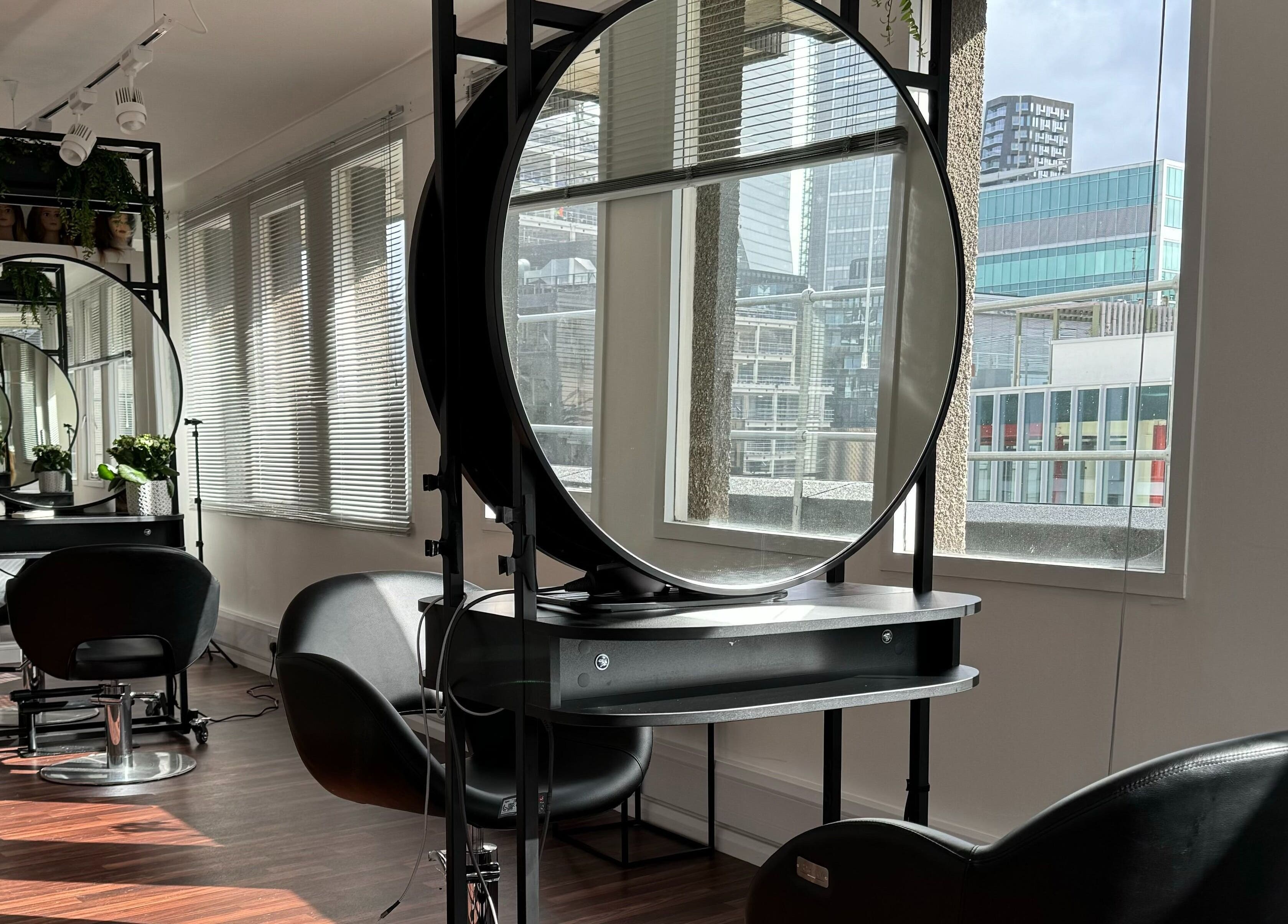 Bright, modern salon with round mirrors at Zoey Olechnowicz Hair Colourist, London, England, GB.