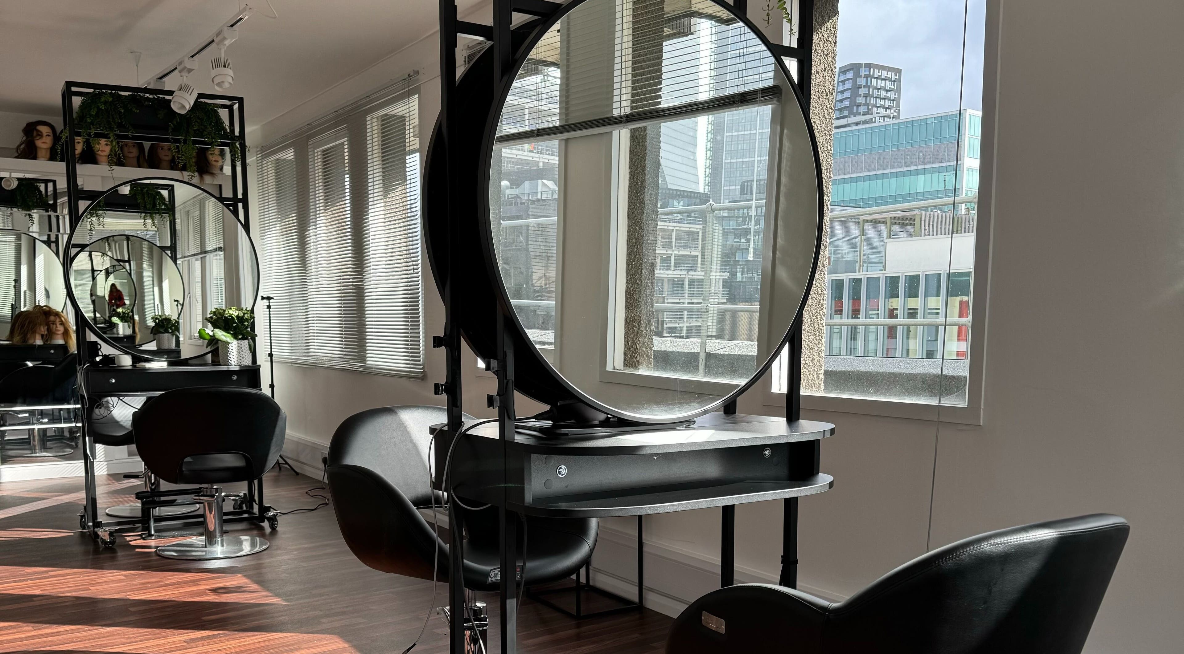 Bright, modern salon with round mirrors at Zoey Olechnowicz Hair Colourist, London, England, GB.