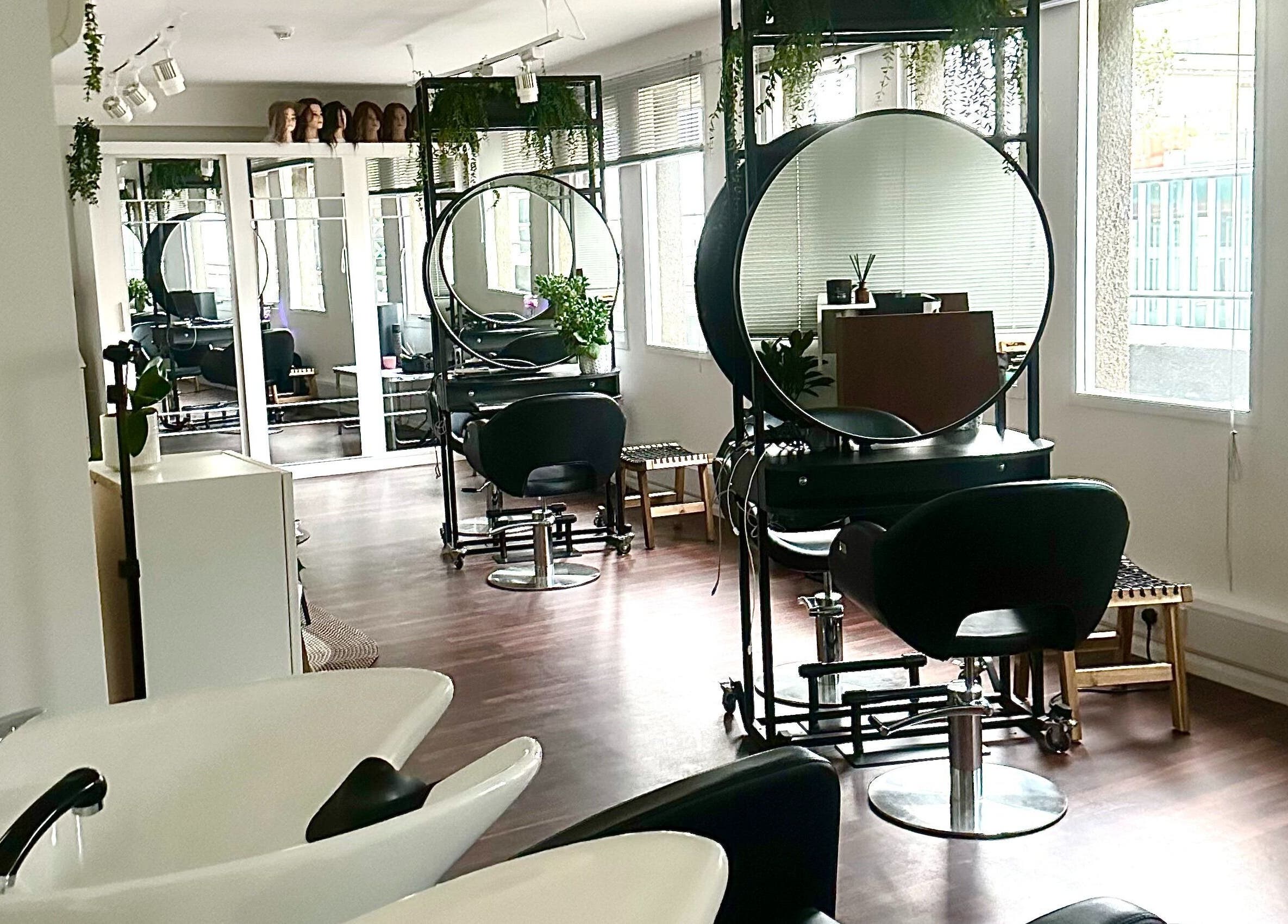 Modern salon interior at Zoey Olechnowicz Hair Colourist, London, England, GB, featuring stylish chairs and mirrors.