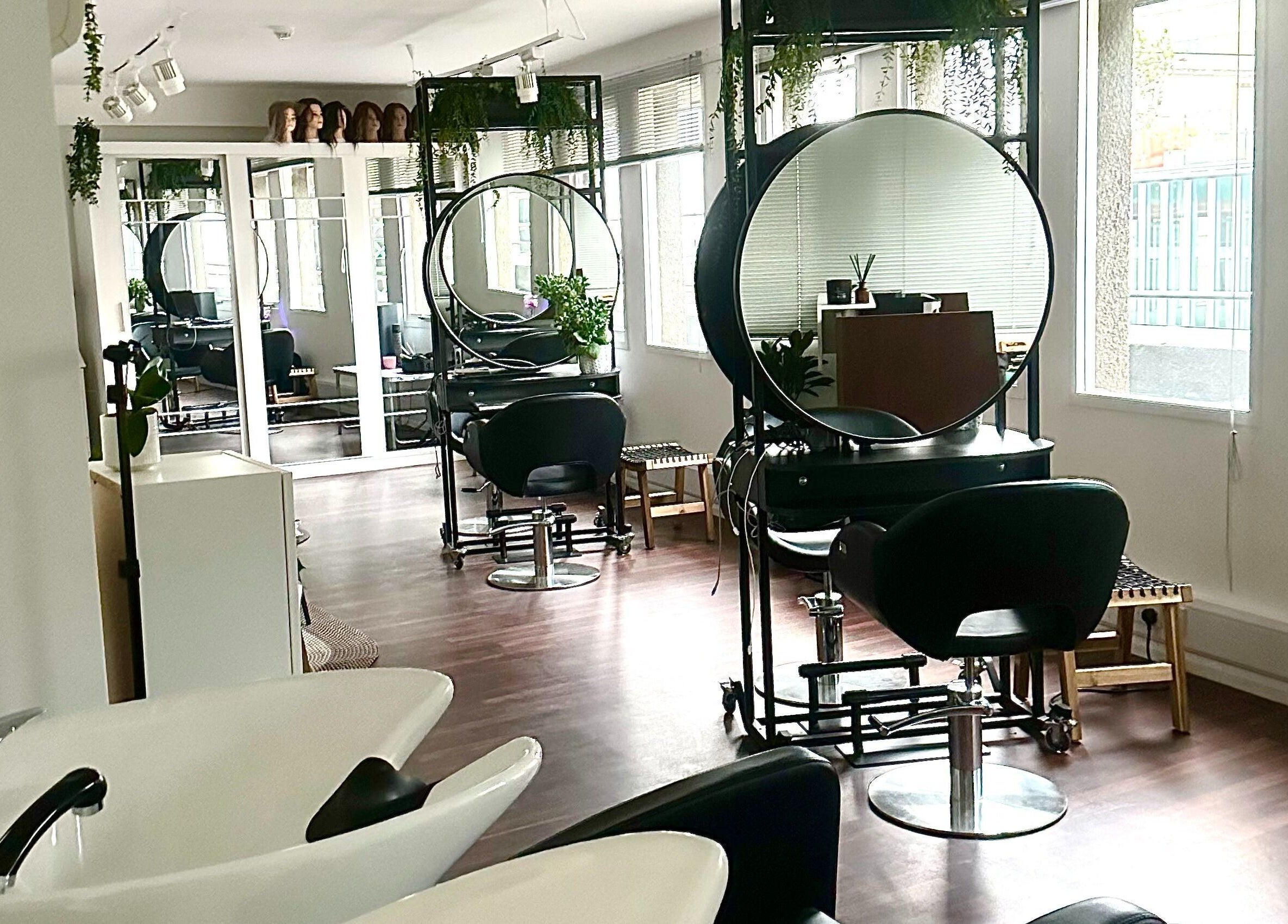 Modern salon interior at Zoey Olechnowicz Hair Colourist, London, England, GB, featuring stylish chairs and mirrors.
