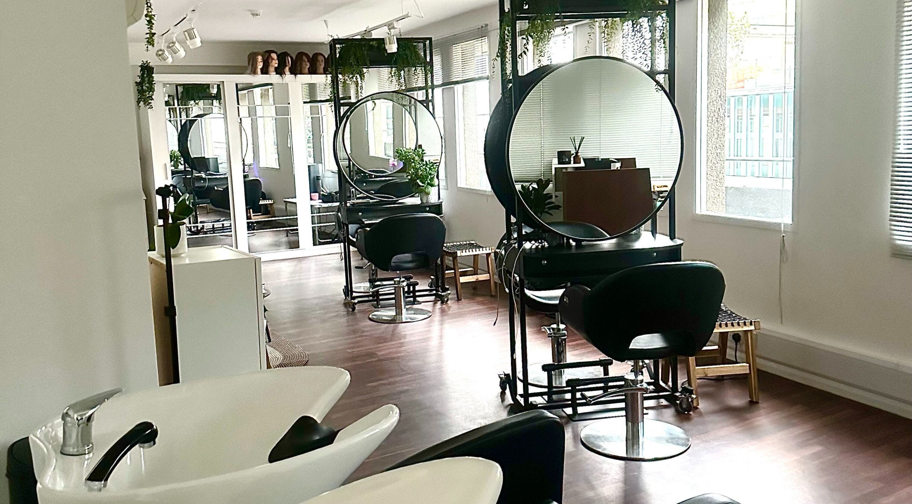 Modern salon interior at Zoey Olechnowicz Hair Colourist, London, England, GB, featuring stylish chairs and mirrors.