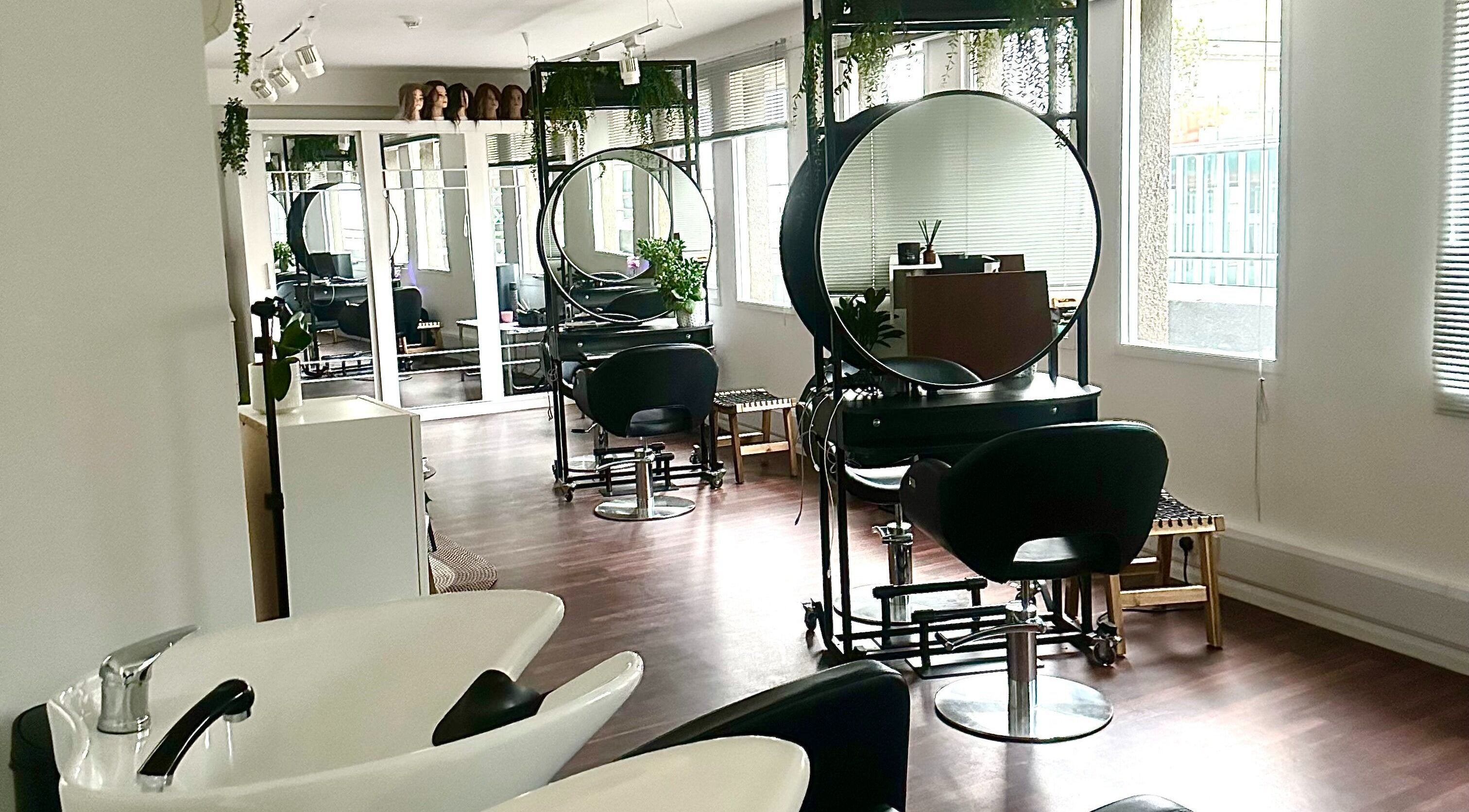 Modern salon interior at Zoey Olechnowicz Hair Colourist, London, England, GB, featuring stylish chairs and mirrors.