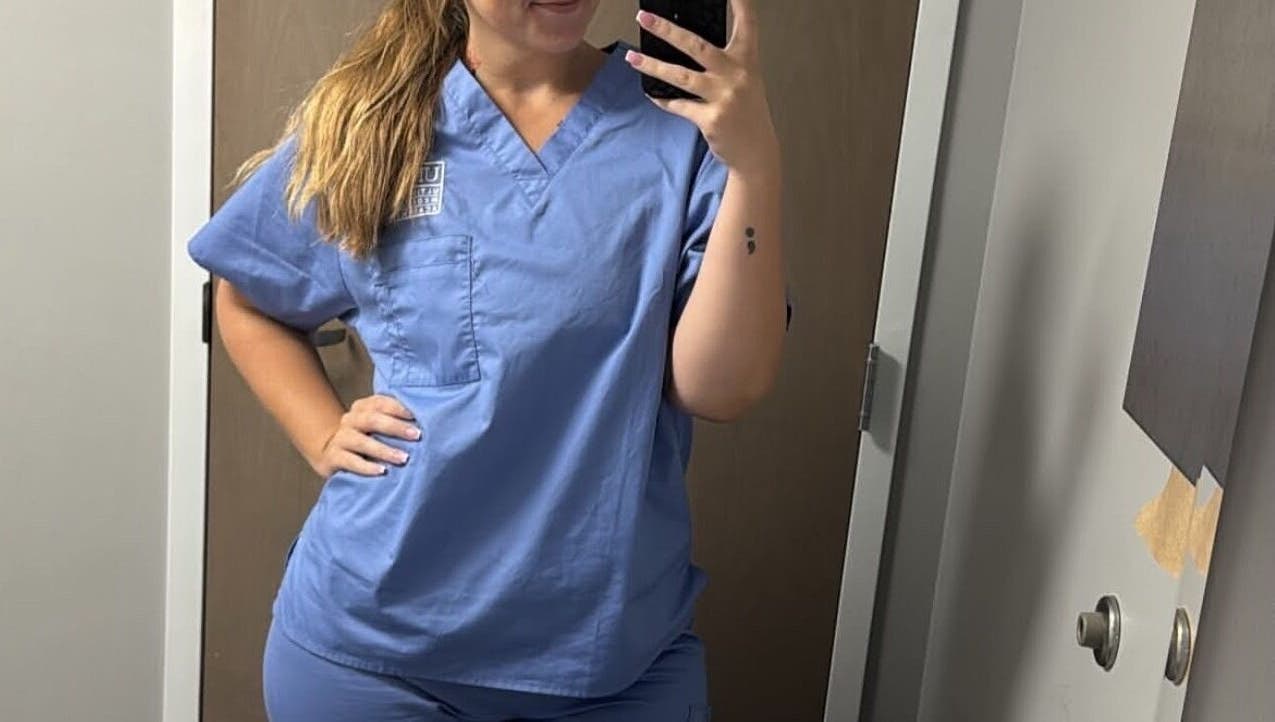 Staff member in uniform at Golden Grace Wellness Spa, Warwick, Rhode Island, US.