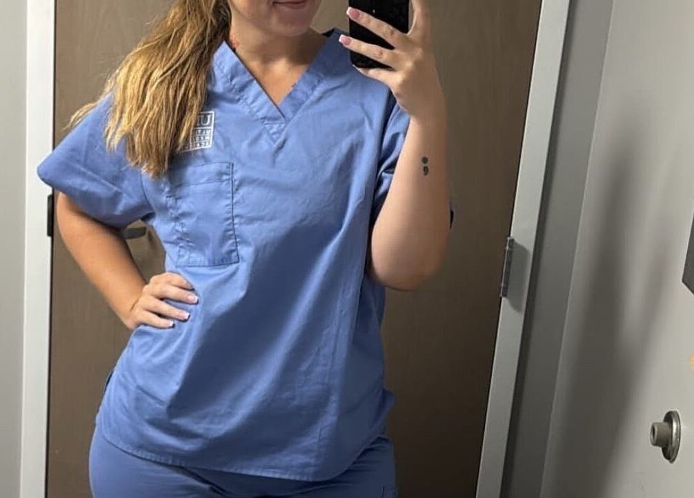 Staff member in uniform at Golden Grace Wellness Spa, Warwick, Rhode Island, US.