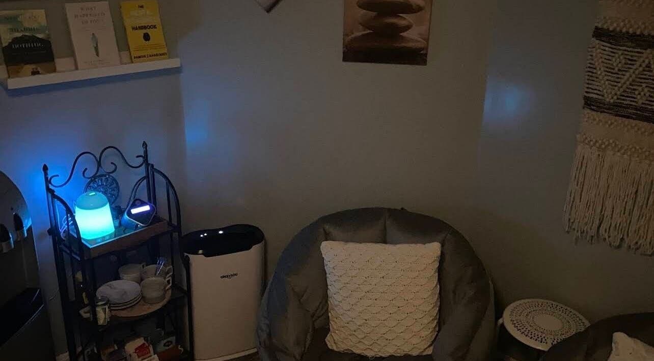 Cozy reading corner at Golden Grace Wellness Spa, Warwick, Rhode Island, US illuminated by soft blue light.