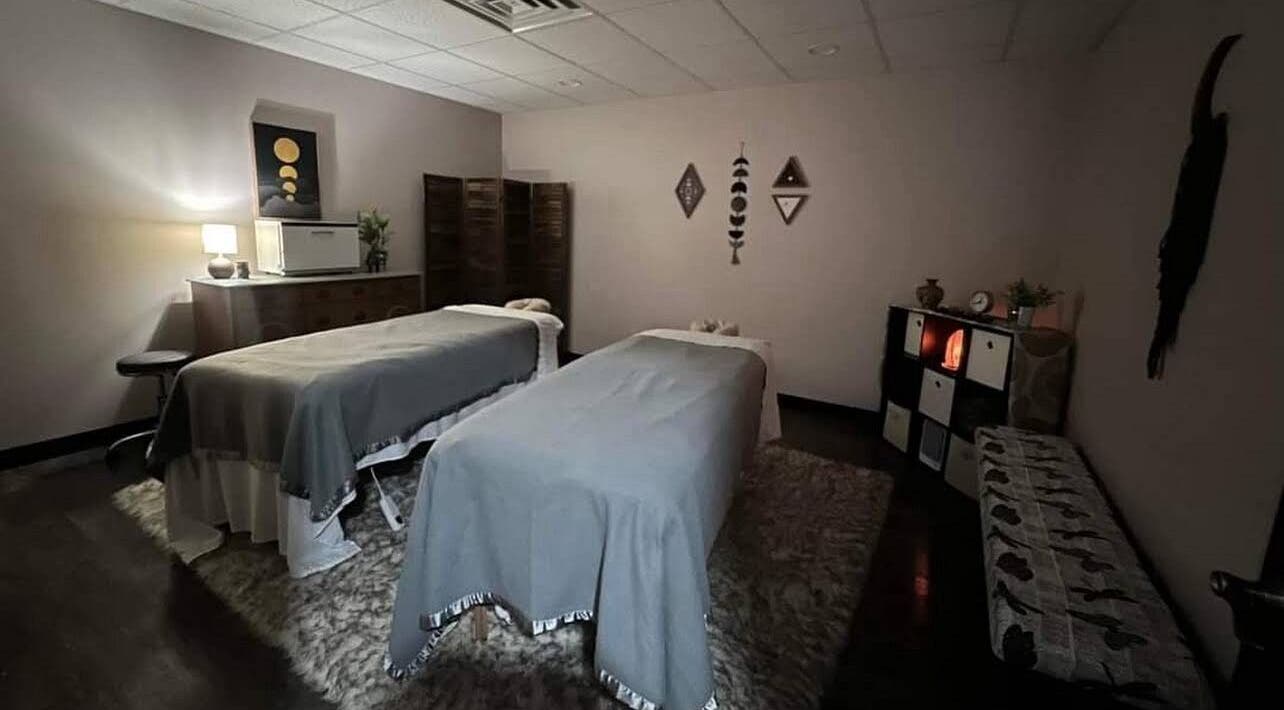 Relaxing massage room at Golden Grace Wellness Spa, Warwick, Rhode Island, US with two therapy tables.