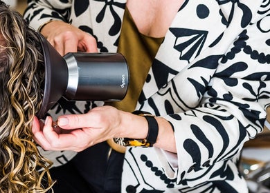 Stylist using hairdryer on client at Curly & Co Hair, Tweed Heads, New South Wales, AU.