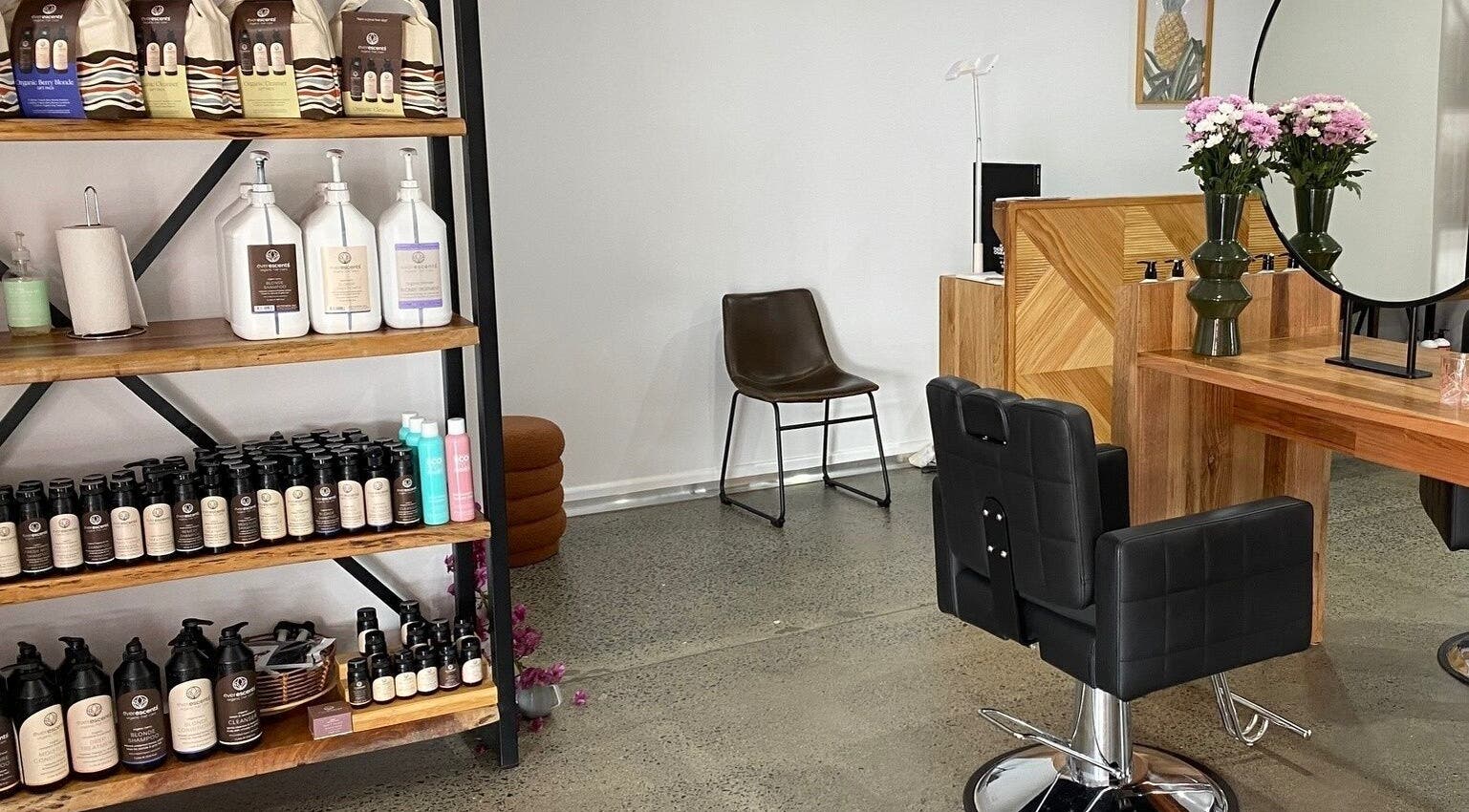 Stylish salon interior at Curly & Co Hair, Tweed Heads, New South Wales, AU, featuring products and seating.