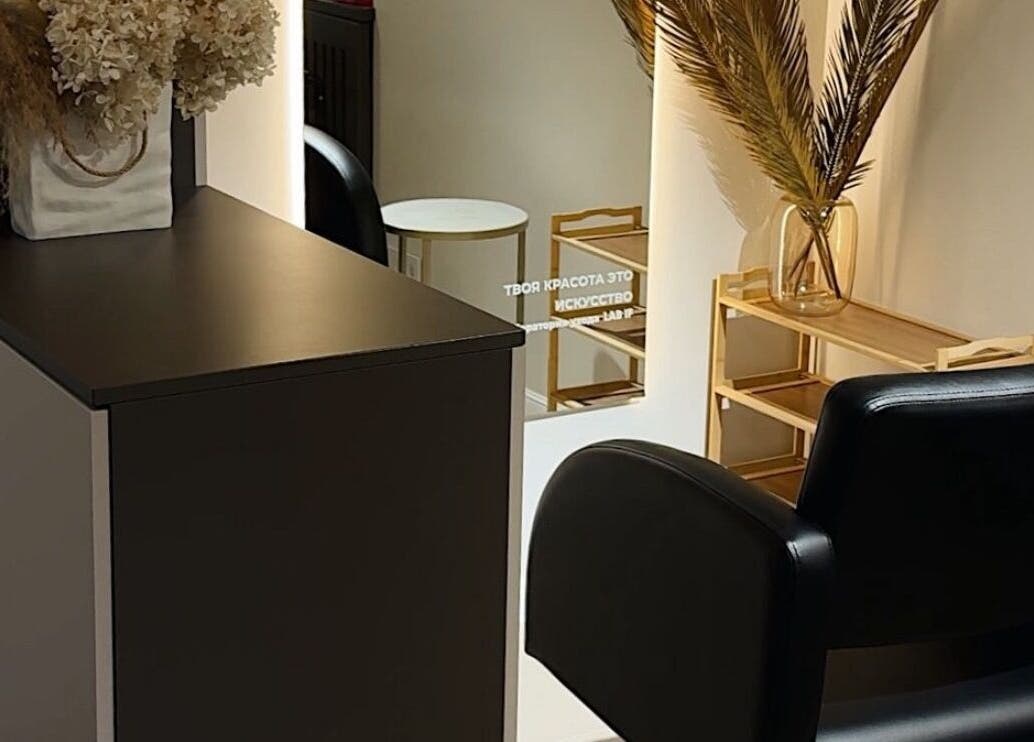 Elegant salon corner at Braids Bank, South Croydon, England, GB with chic decor and a comfortable chair.