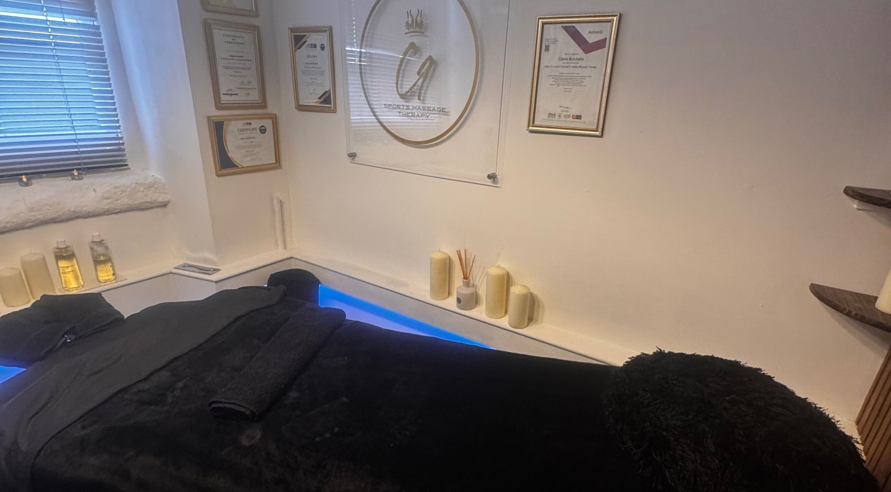 Tranquil massage room at Harmony Hands Derby in Derby, England, GB, featuring a comfortable black massage table.