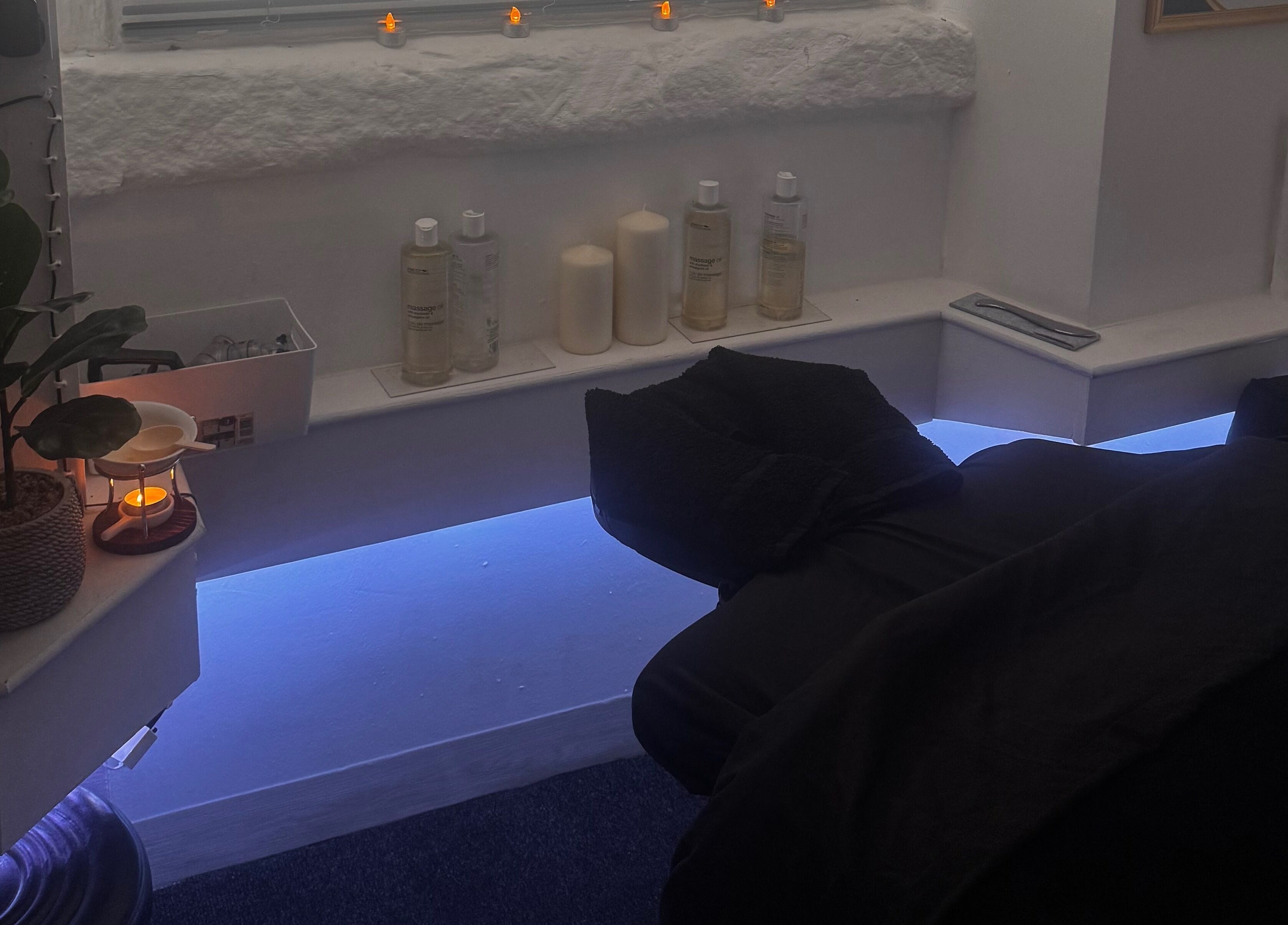 Relaxing treatment room at Harmony Hands Derby featuring soft lighting and massage bed, Derby, England, GB.