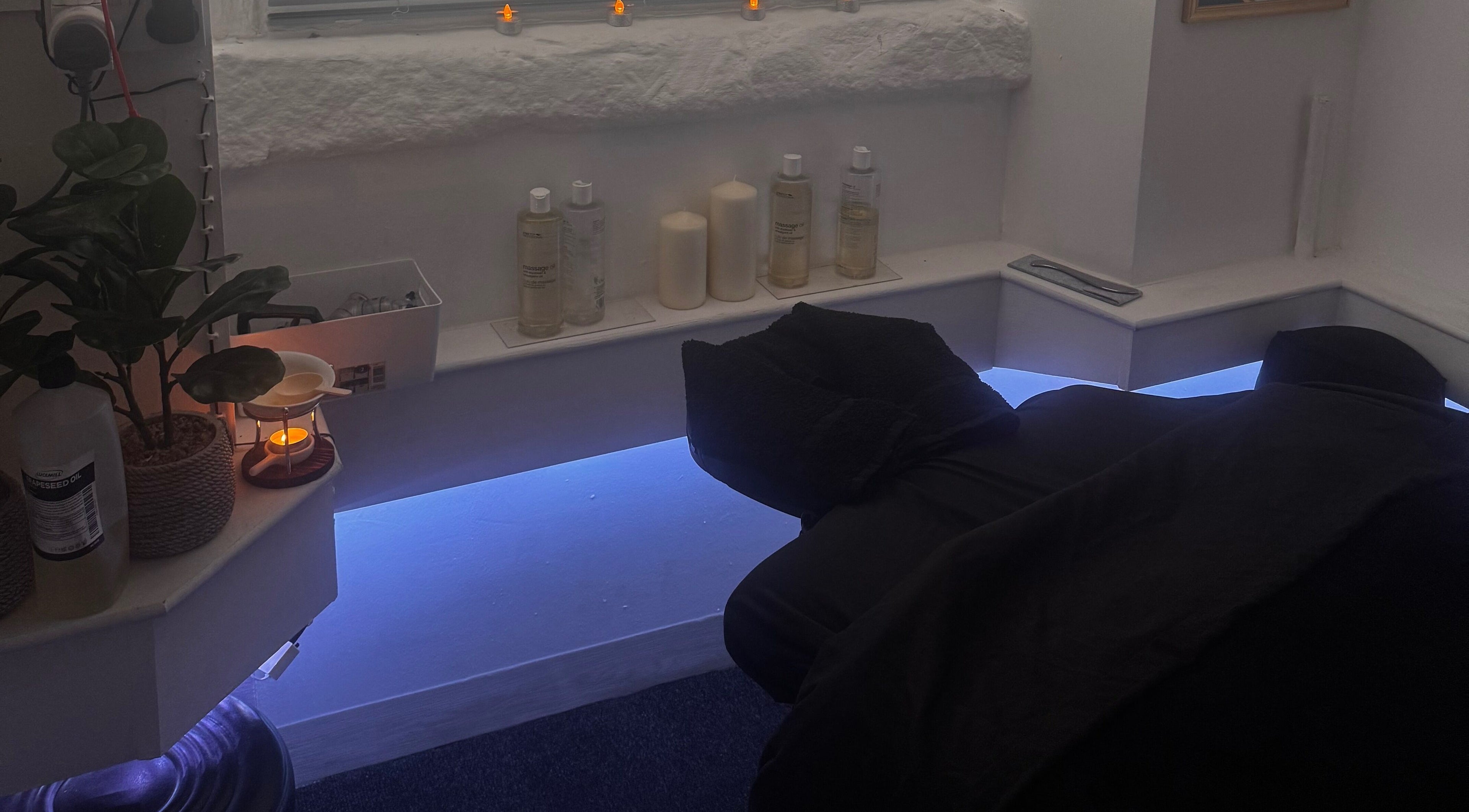Relaxing treatment room at Harmony Hands Derby featuring soft lighting and massage bed, Derby, England, GB.