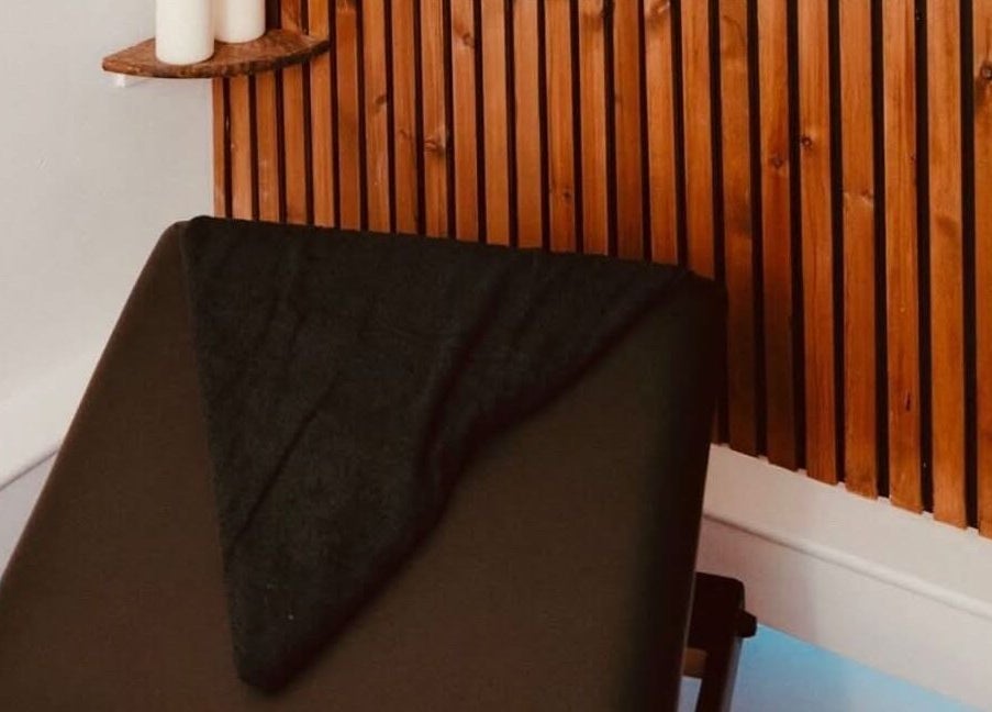 Relaxing massage bed at Harmony Hands Derby showcasing brown wood decor in Derby, England, GB.
