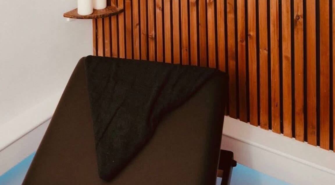 Relaxing massage bed at Harmony Hands Derby showcasing brown wood decor in Derby, England, GB.