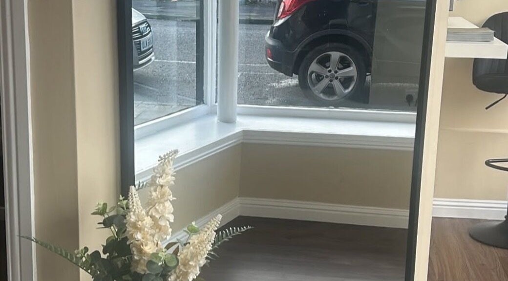 Chic corner with window, mirror, and flowers at Hair by Casey, Edinburgh, Scotland, GB.
