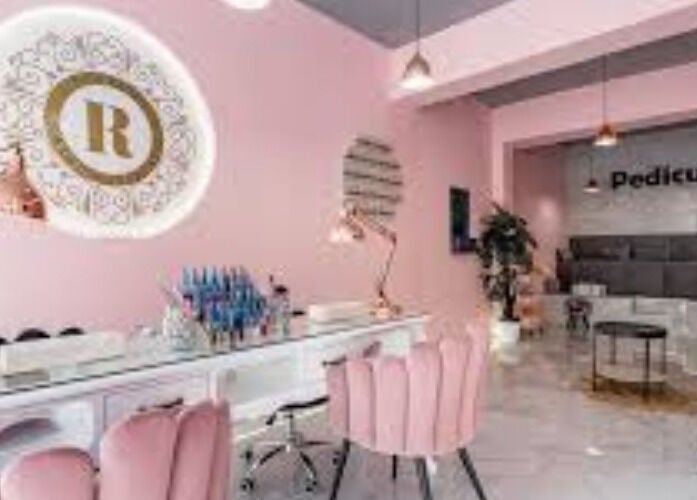 Elegant pink and gold salon interior at EJEMPLO, Santander, Santander, CO offering pedicure services.