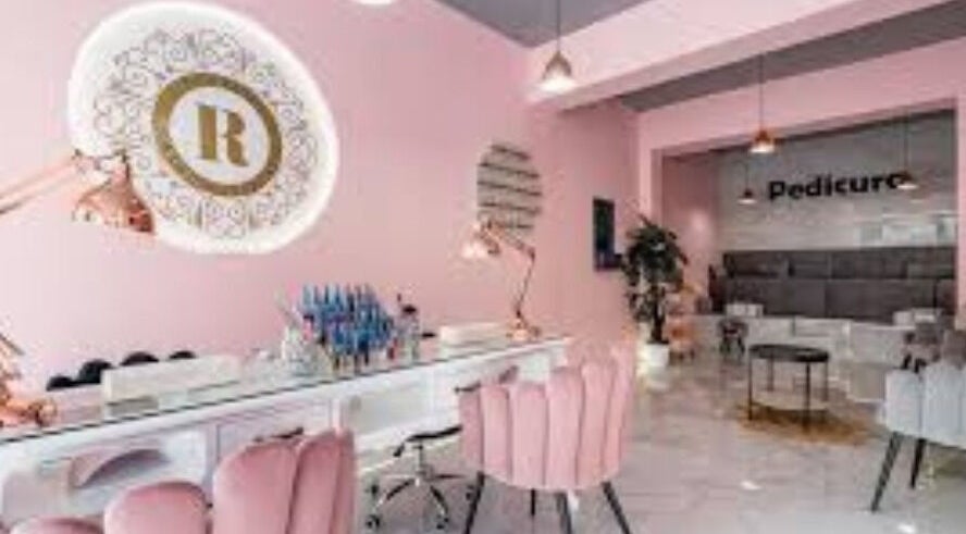Elegant pink and gold salon interior at EJEMPLO, Santander, Santander, CO offering pedicure services.