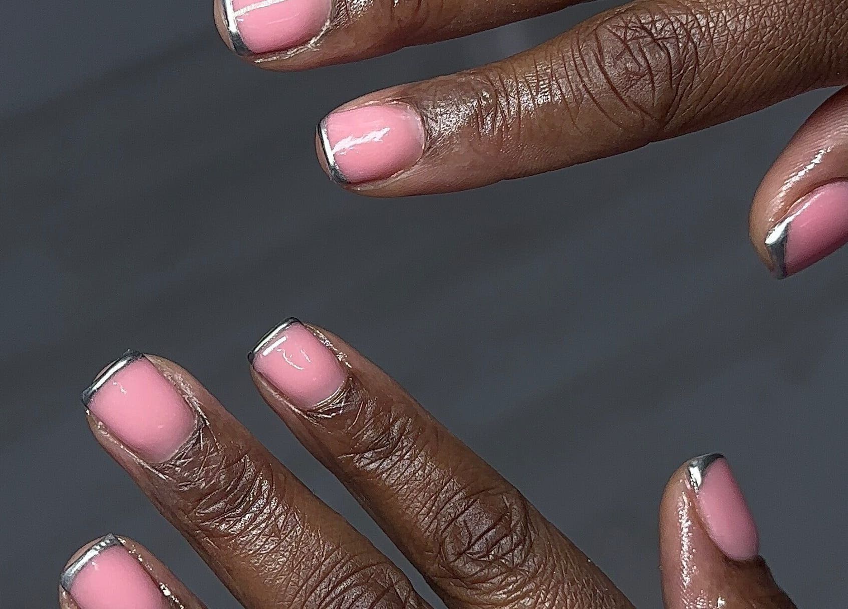 Stylish pink manicure with silver tips at Nailedbylaurinda, Birmingham, England, GB.